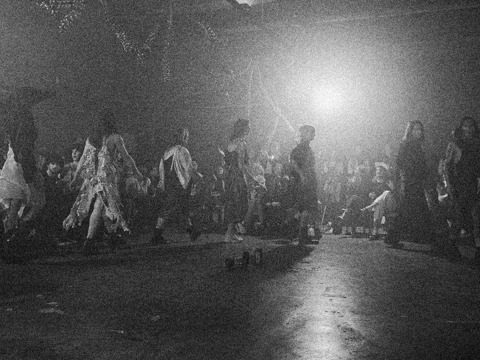 Several people partake in a fashion show performance.