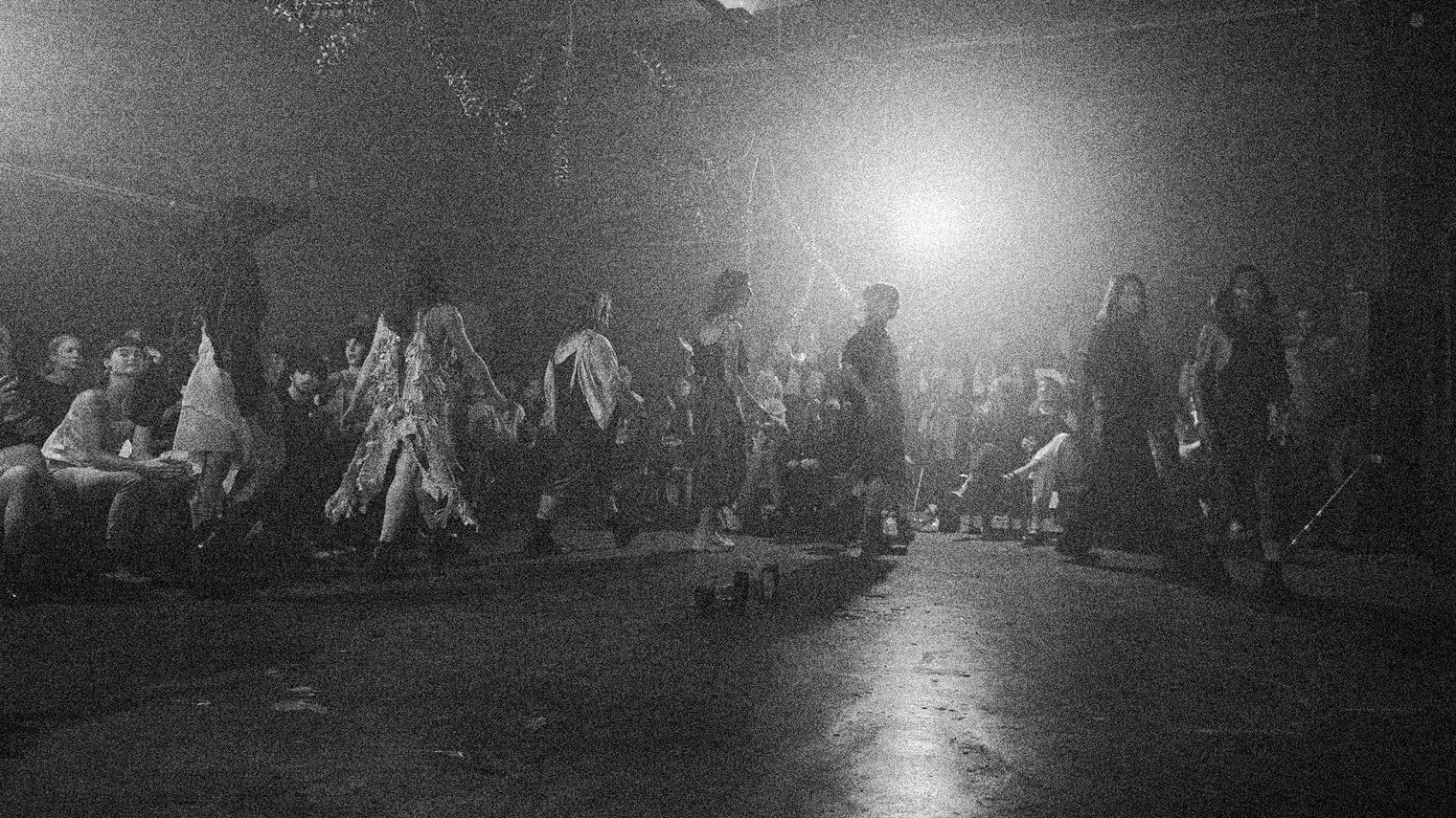 Several people partake in a fashion show performance.