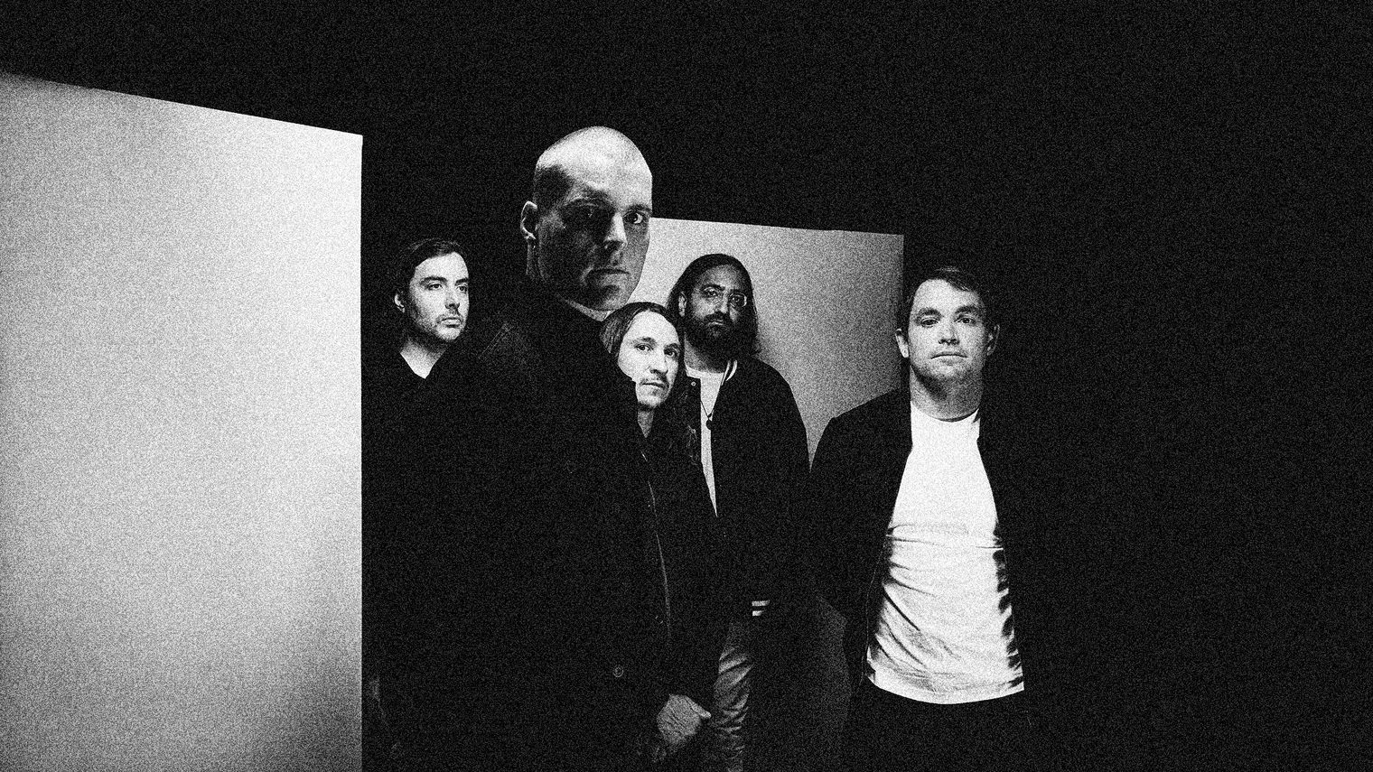 Greyscale image of the members of Deafheaven, standing together looking towards the camera.