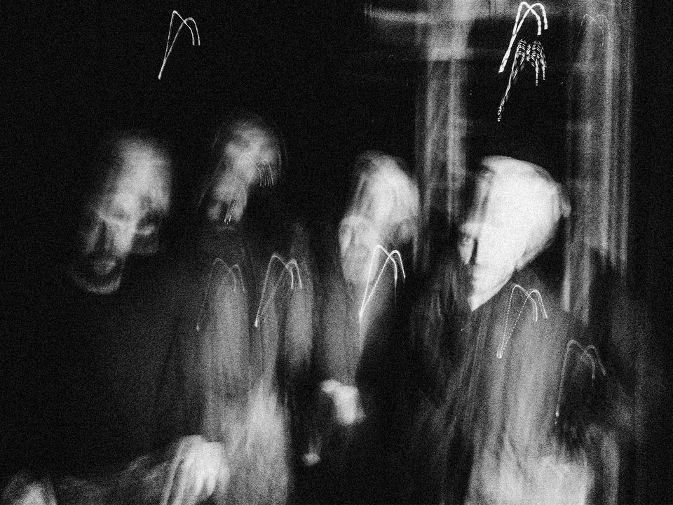 Highly blurred, abstract greyscale shot of the YLVA band members.