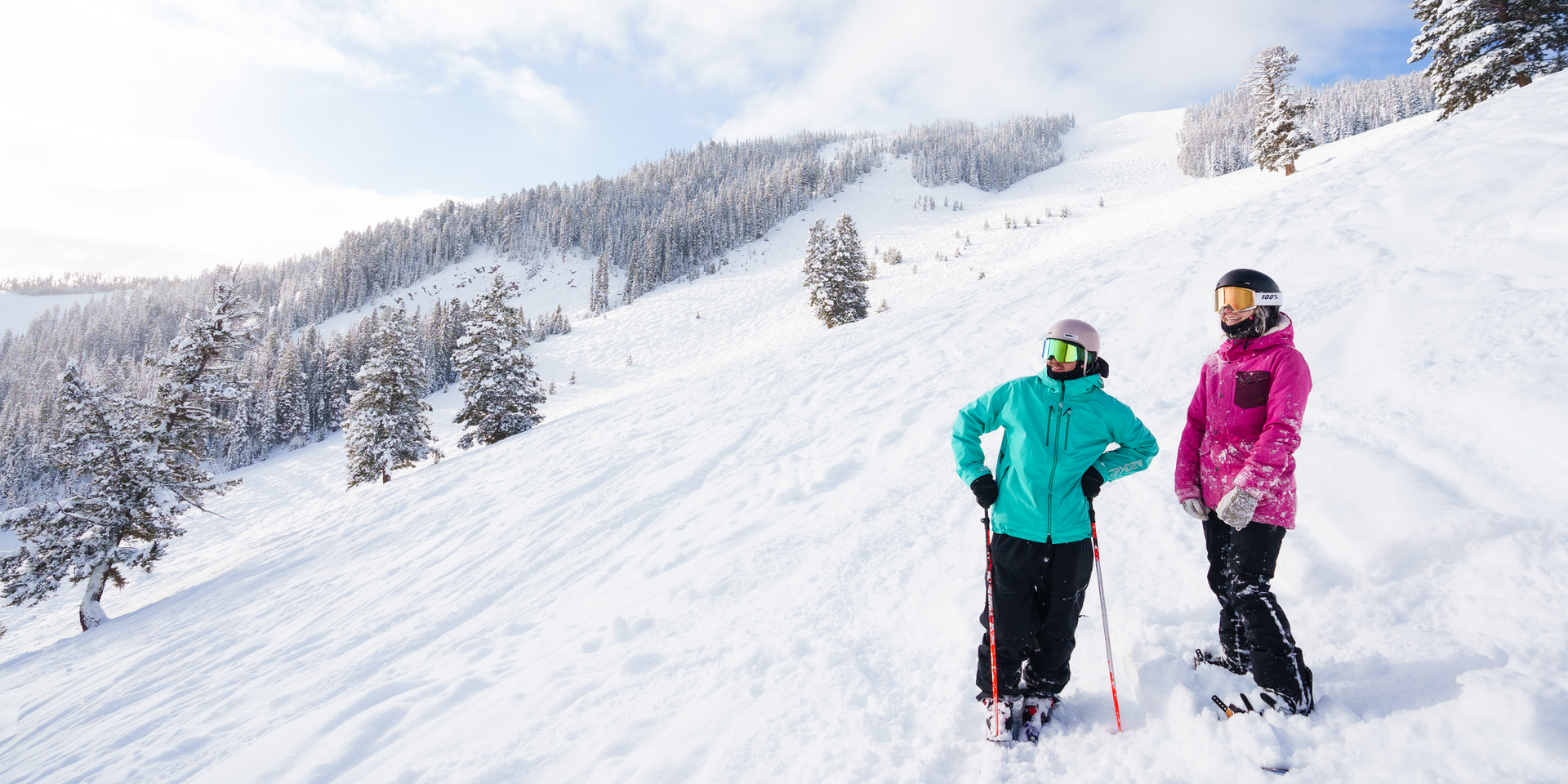 Skier and snowboarder on a groomed run