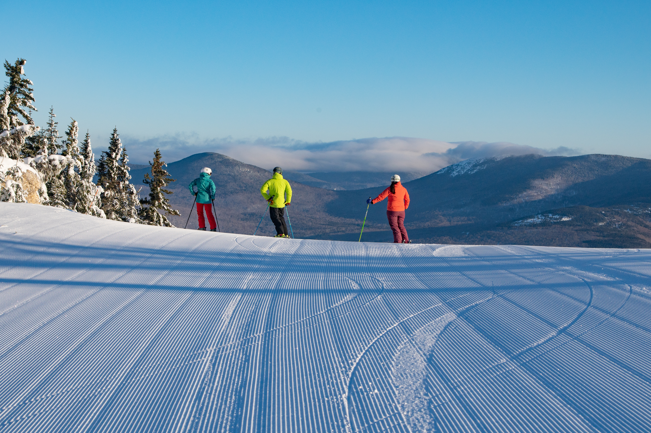 Perfect Corduroy and 3 Skiers Enjoy a Scenic View