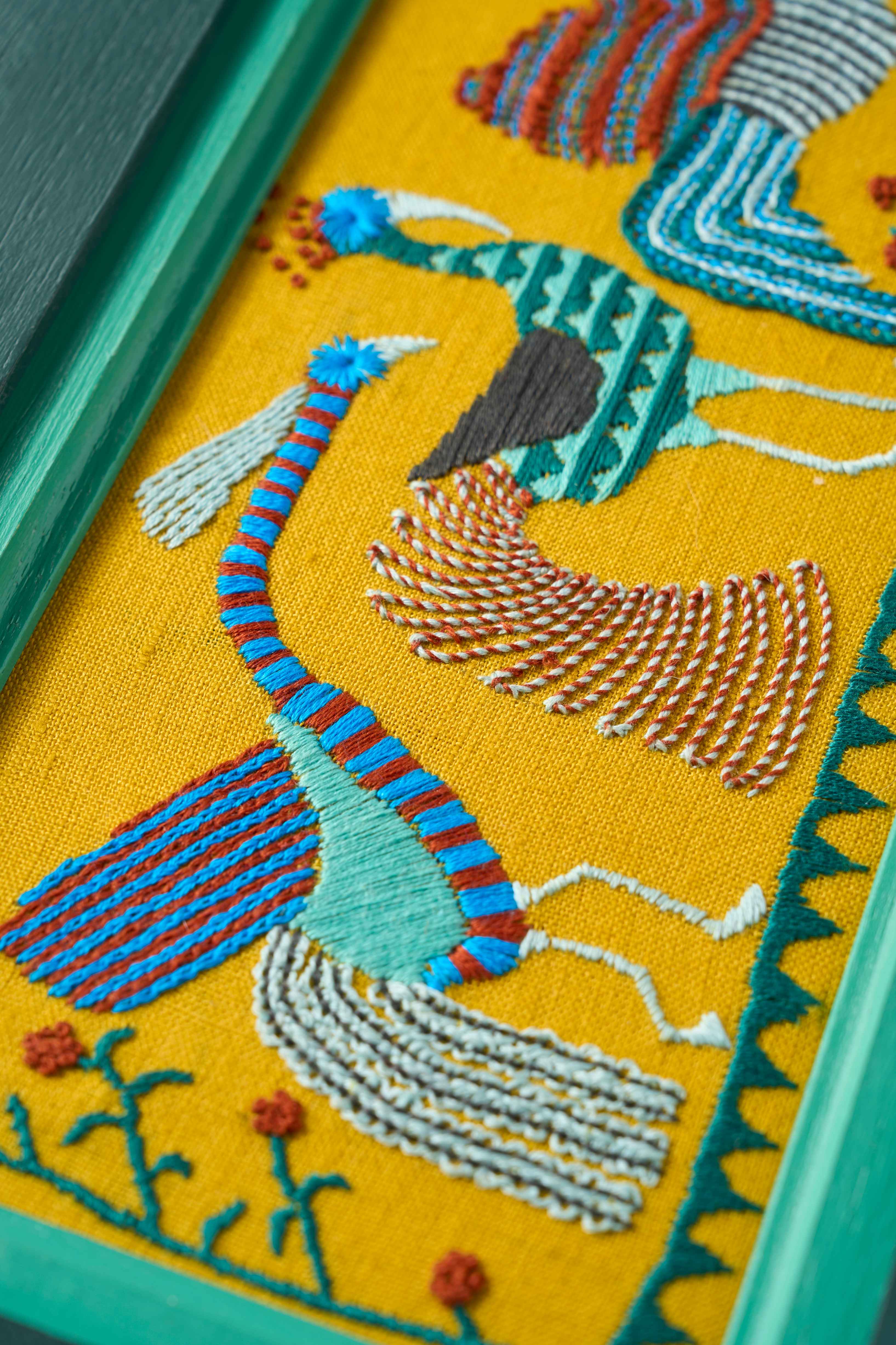 Close up of the limited edition embroidery The Bird Court from The Fabled Thread on yellow fabric in a painted frame