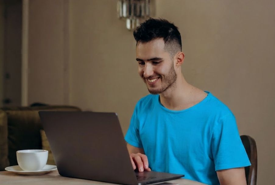 Image of a man on a computer.