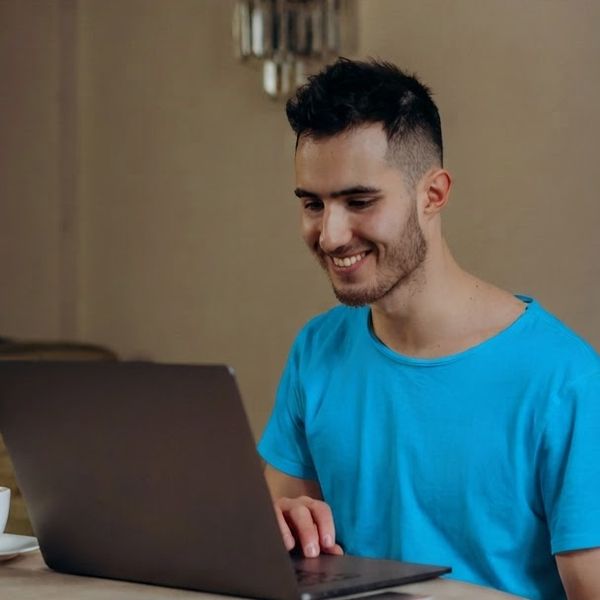 Image of a man on a computer.
