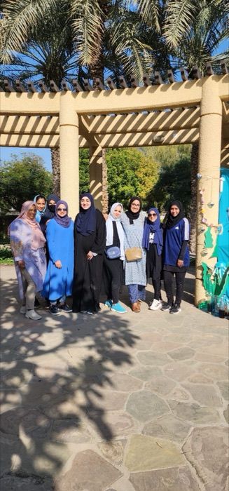 Dubai chapter members gathered outdoors among palm trees
