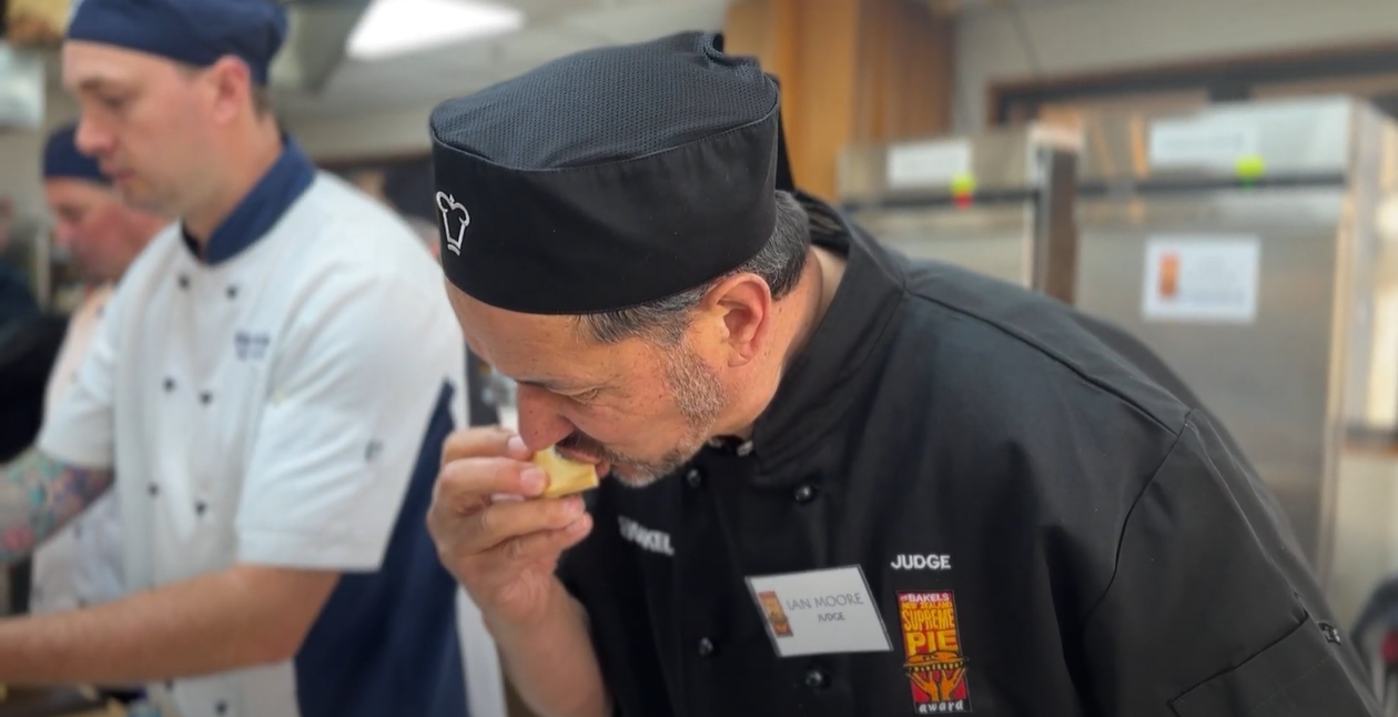 Judge Ian Moore sampling a steak and cheese entry. Photo/PMNNews