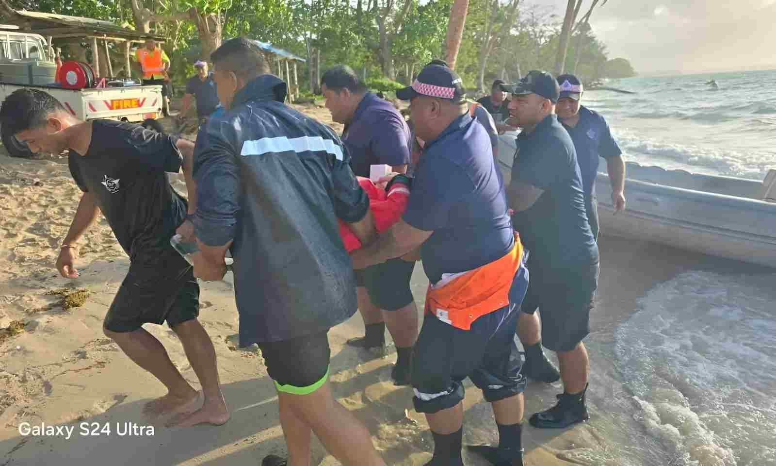 First-responders help rescue the crew of HMNZS Manawanui.