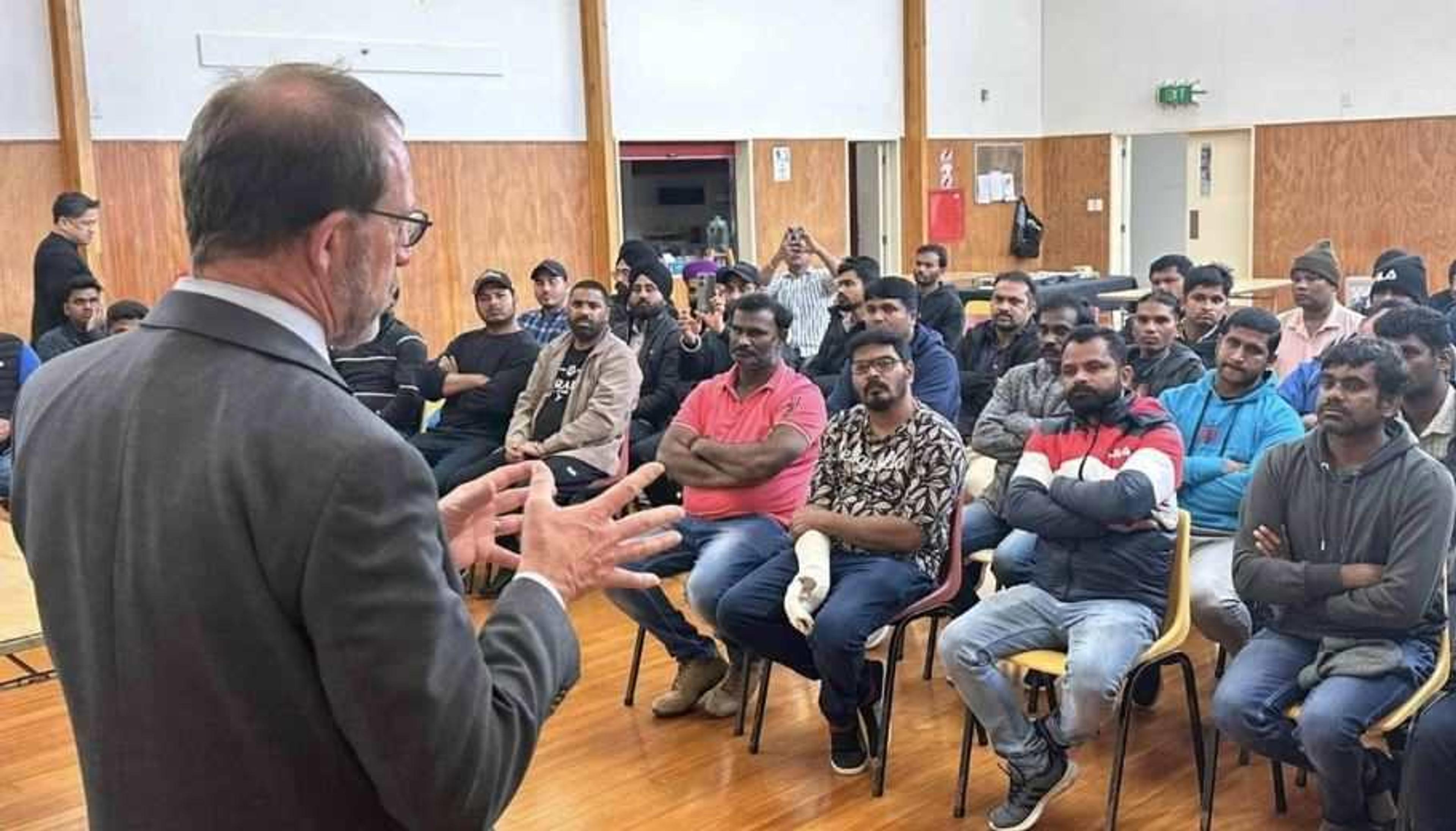 ​Immigration Minister Andrew Little speaks to a group of migrant workers stranded without jobs at a meeting in Auckland. Photo/Facebook/Phil Twyford/via wswg