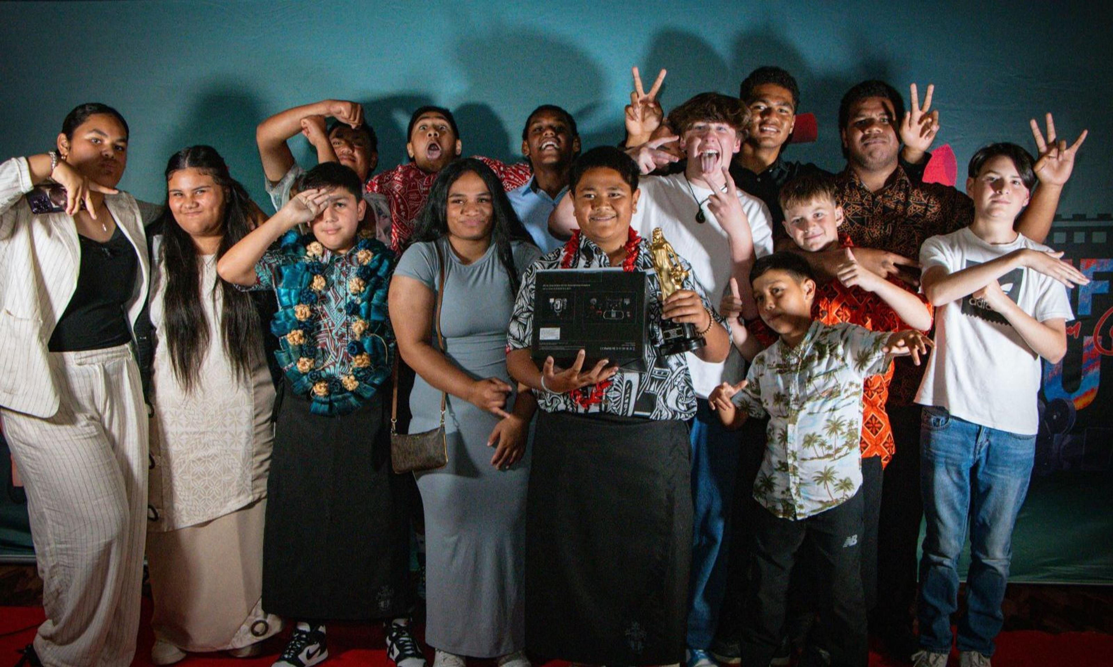 The Pasifika Youth Short Film Competition held its first ever Alofa Awards recognising aspiring filmmakers from Wellington schools. (Pictured) "Viliame" Writer/Director Tomás Satyanand (blue lei) & Best Actor winner Tautiaga Fepulea'i with students from Scots College.