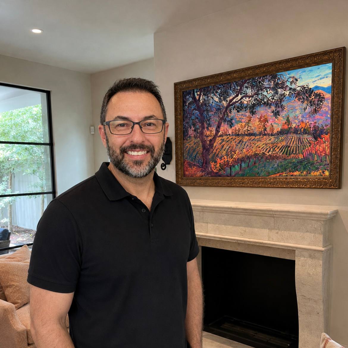Richard Machemehl beside a Samsung Frame TV displaying artwork above a fireplace.