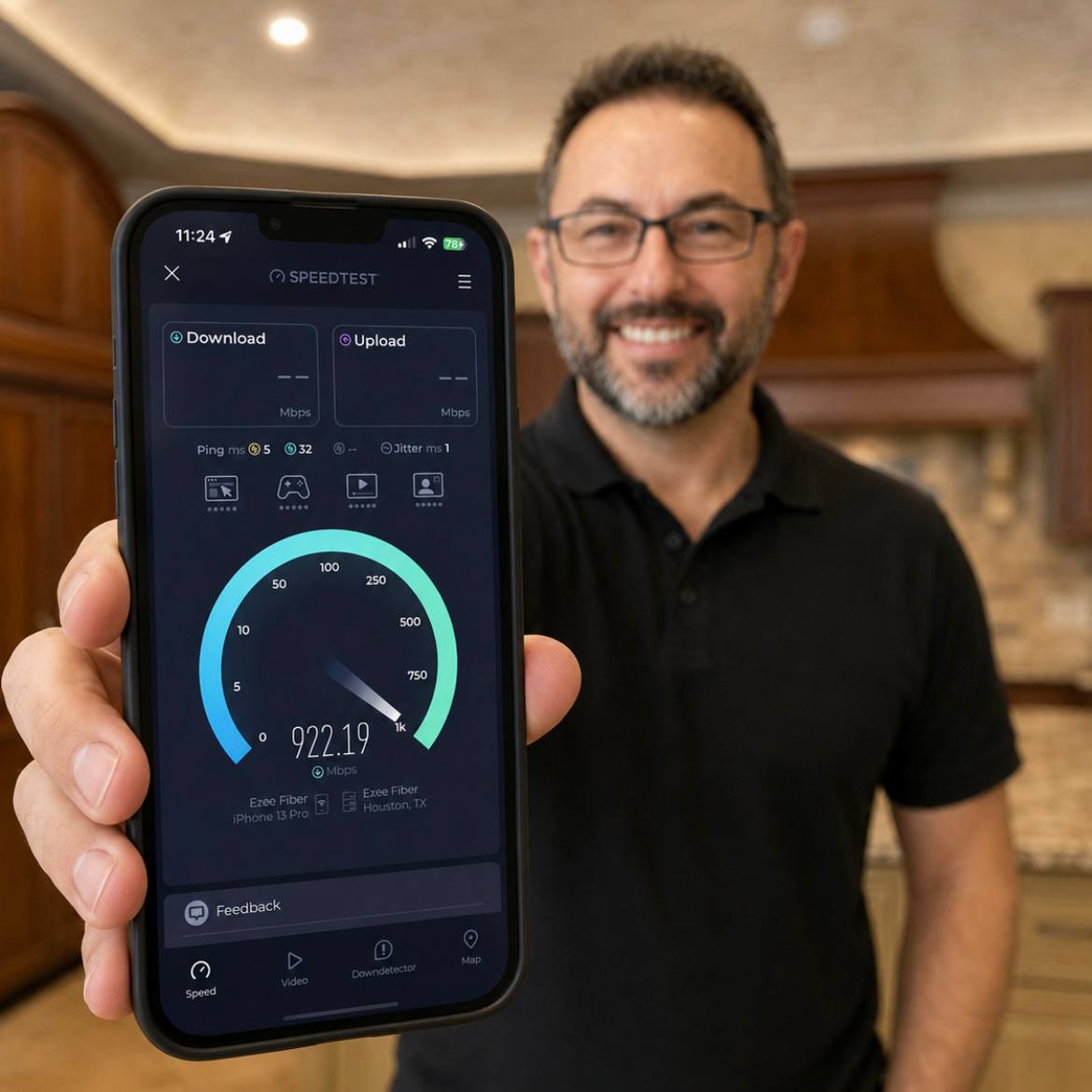 Richard Machemehl holding a phone that shows a high-speed internet test in a Houston home.