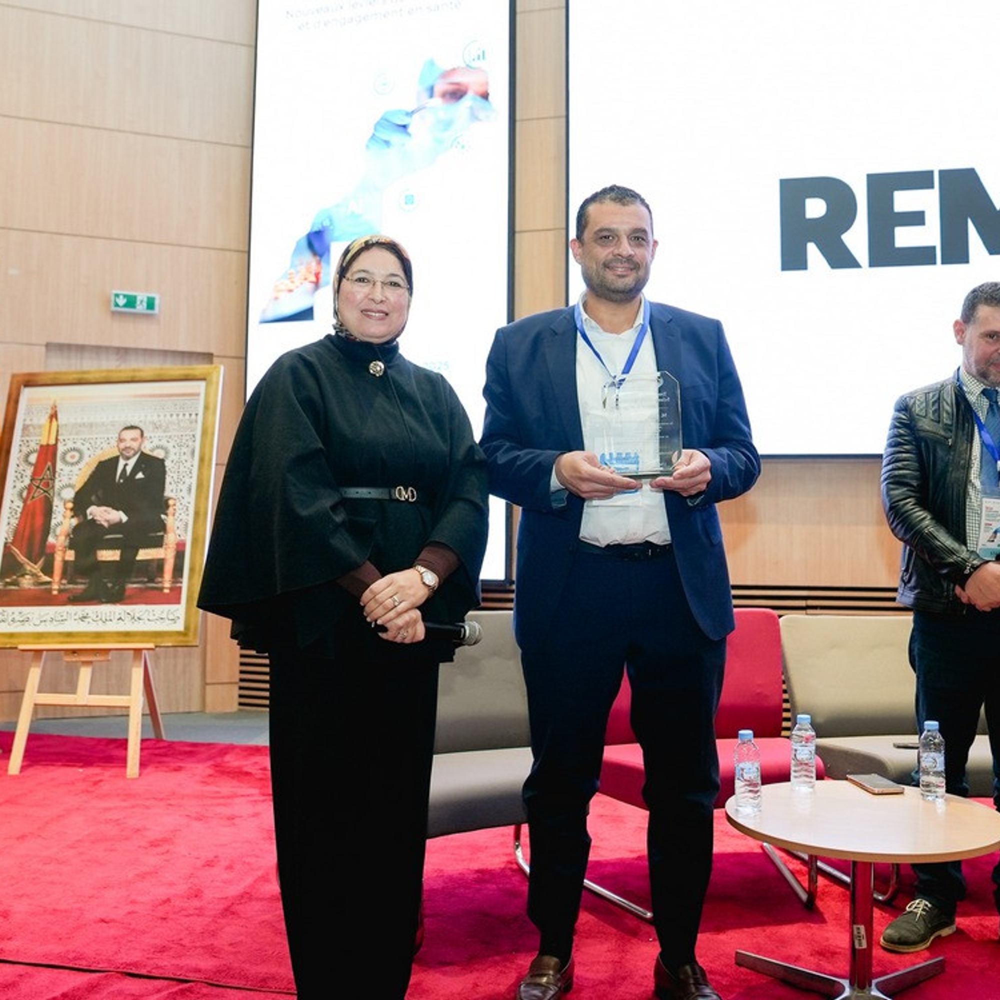 Remise d'un trophée à un intervenant lors de la conférence nationale UM6SS sur l'IA et le marketing pharmaceutique