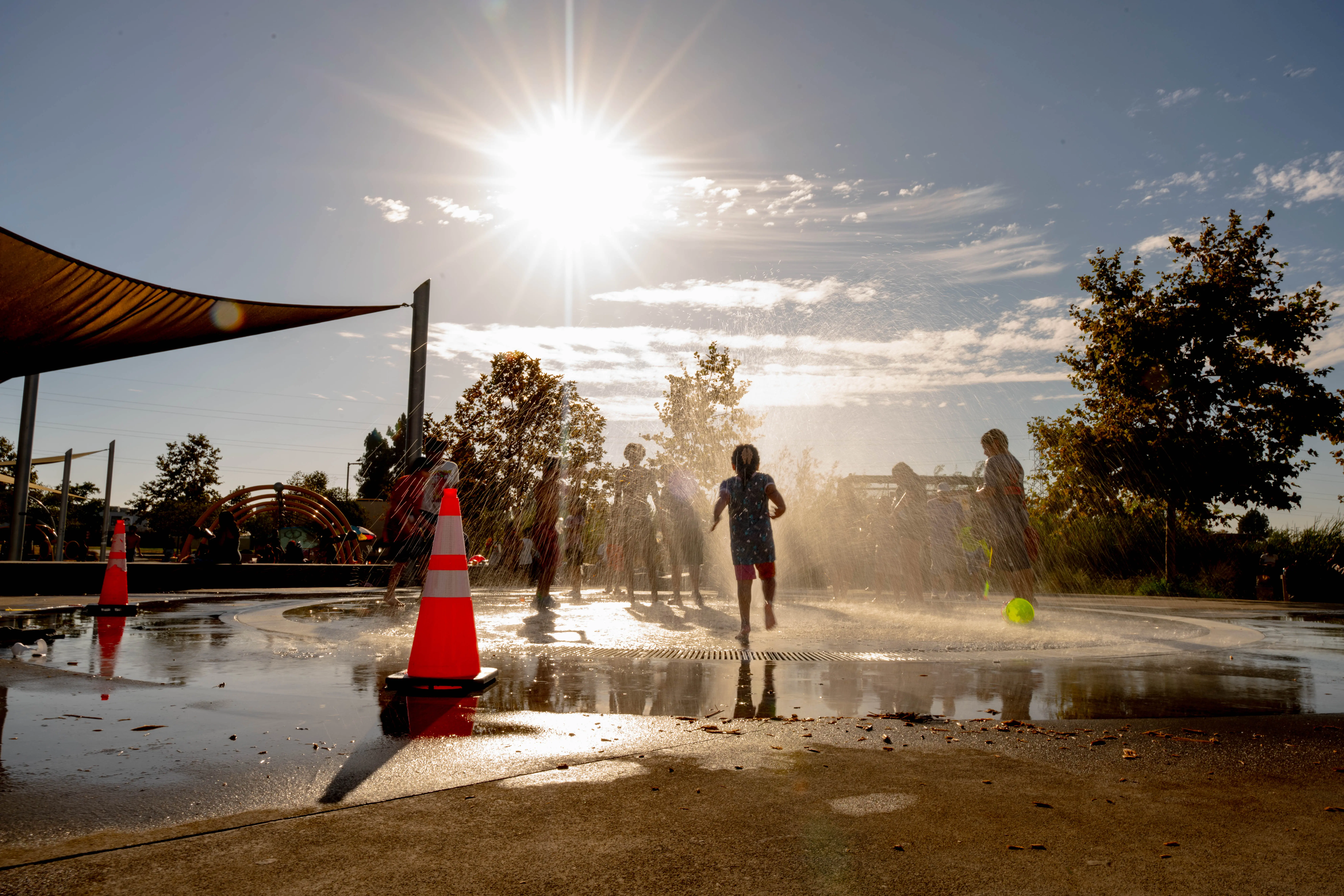 Children playing at a splash pad in South Los Angeles