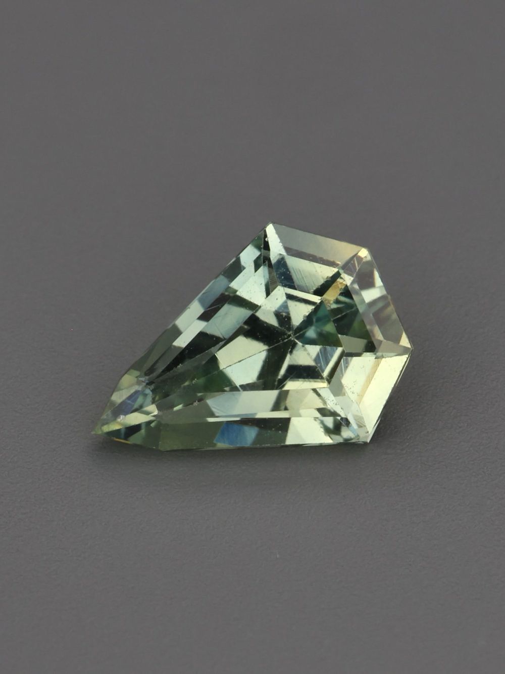 Pale Evergreen Sapphire — 0.63 ct Shield Cut