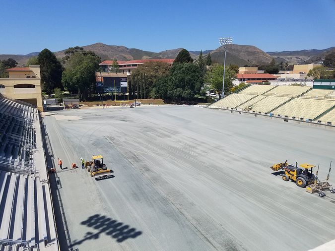 Excavators clear the old grass from Alex G. Spanos Stadium at Cal Poly.