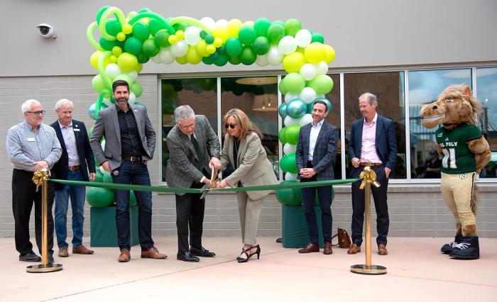 Cindy Villa helps Cal Poly President Jeffrey Armstrong cut the ribbon to open 1901 Marketplace