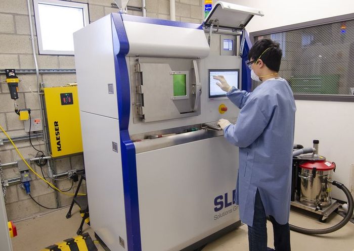 Hajime Yamanaka, an industrial and manufacturing engineering graduate student works on the SLM125HL.
