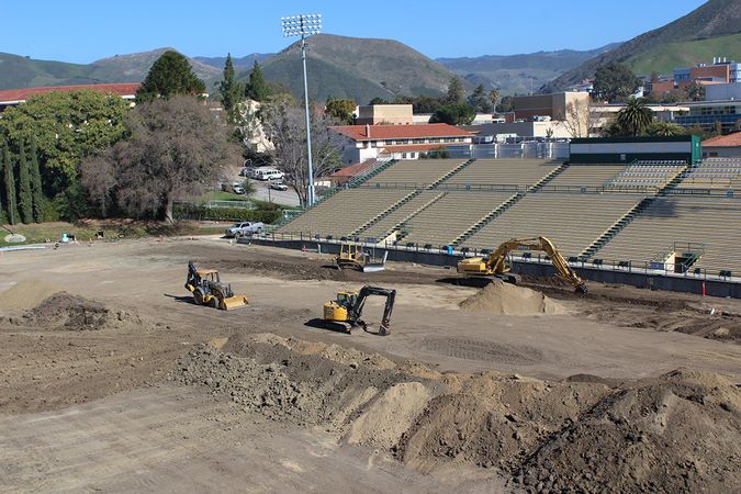 Excavators clear the old grass from Alex G. Spanos Stadium at Cal Poly.