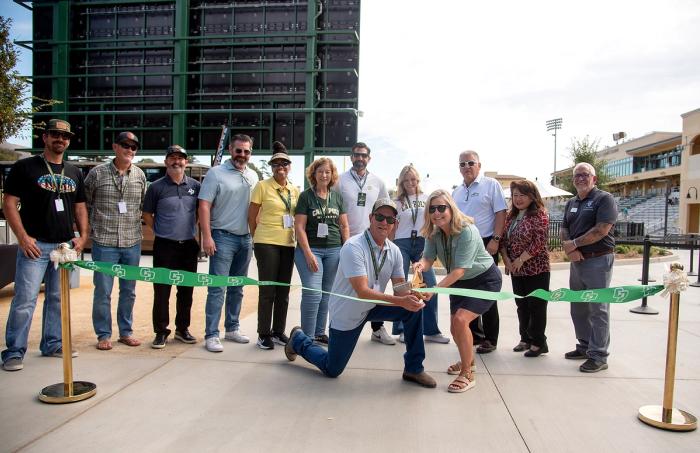 A group of Cal Poly Partners staff and contractors gather to cut the ribbon at the new Cal Poly Partners Plaza in Alex G. Spanos Stadium at Cal Poly San Luis Obispo. 