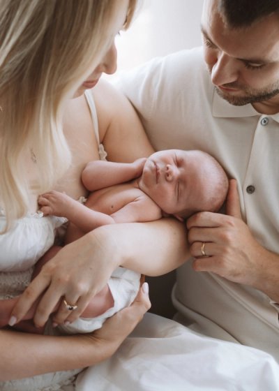 Tender close-up of a parent comforting their newborn baby