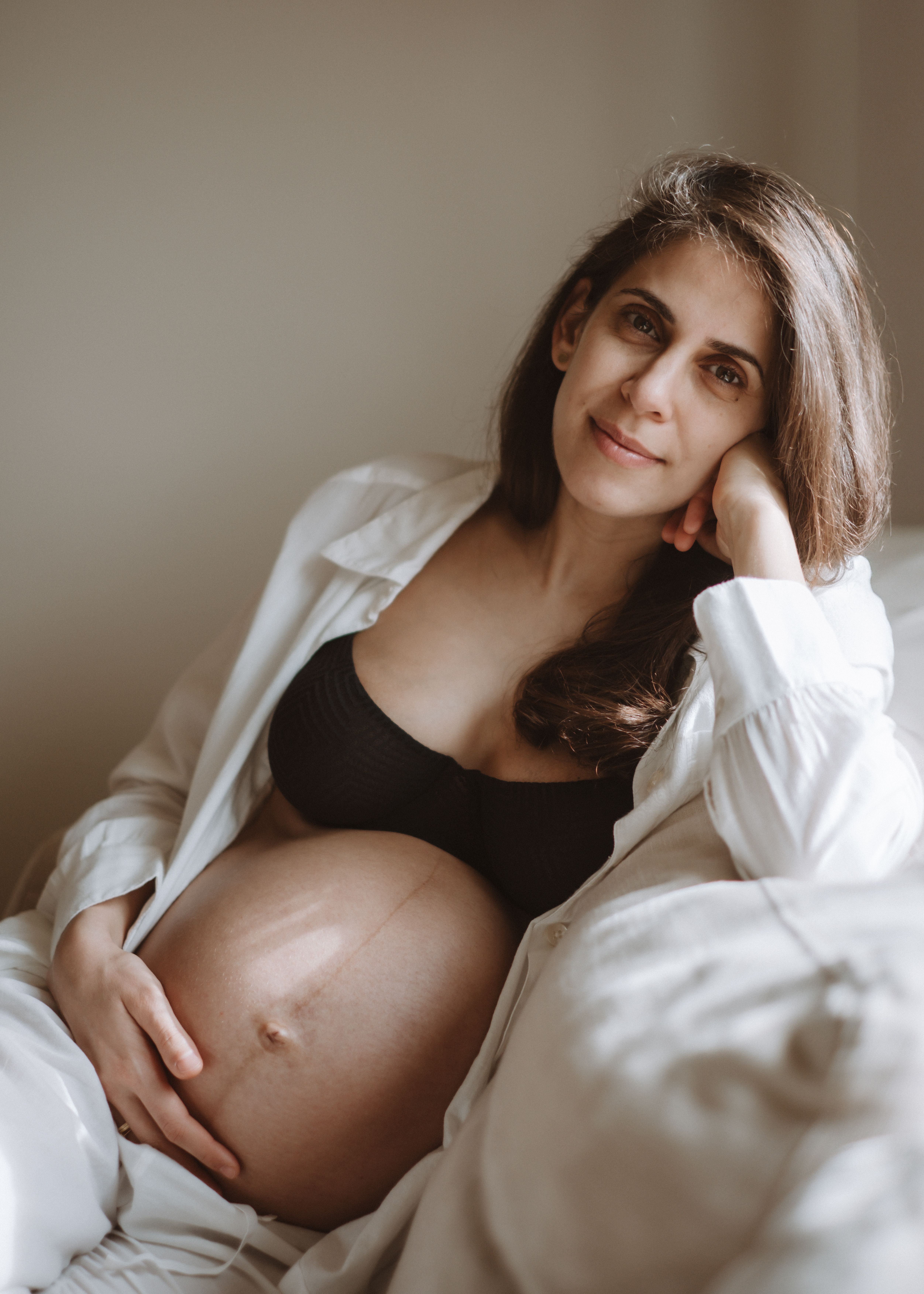 Close-up of an expectant mother cradling her pregnancy bump