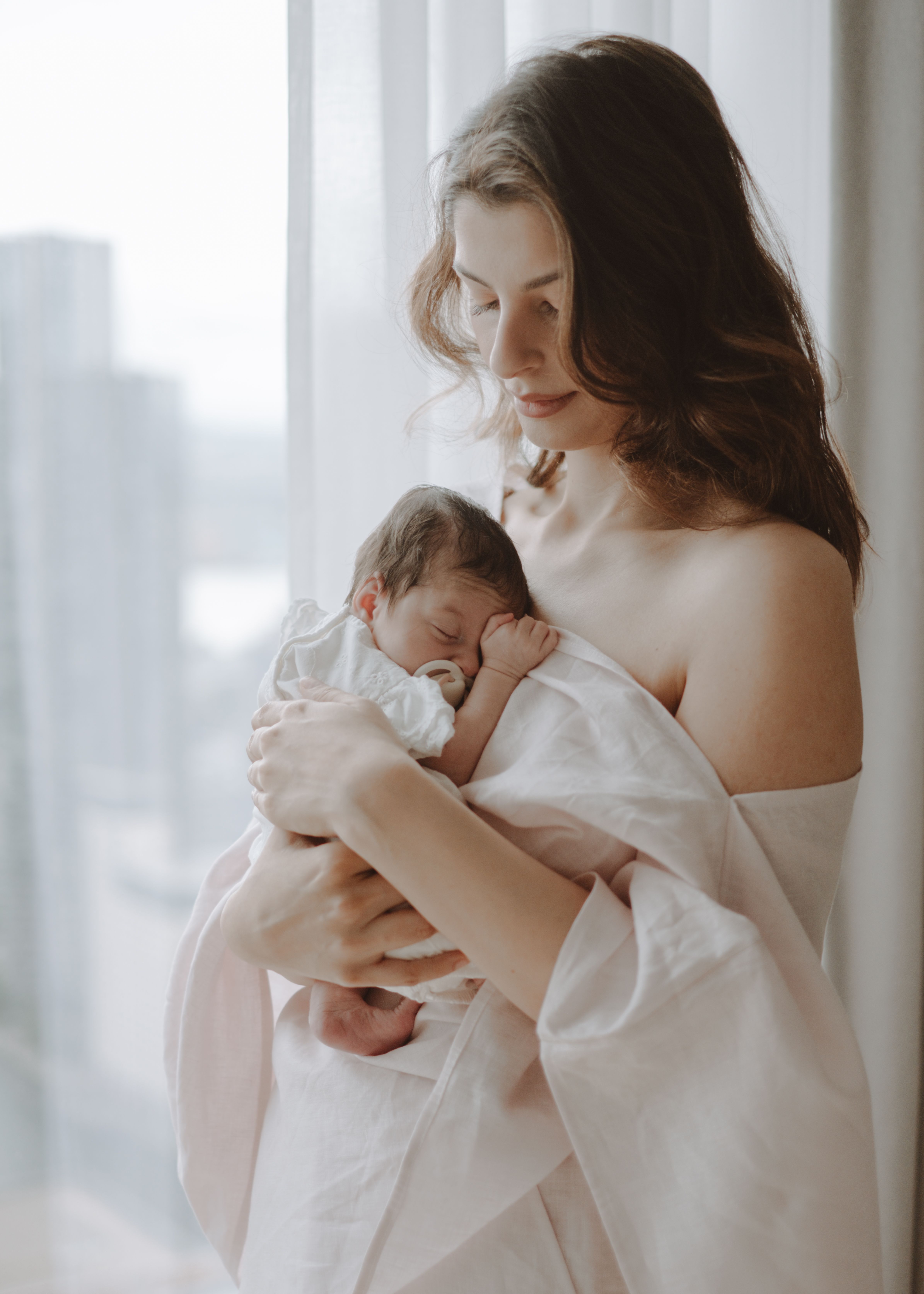 Parents sharing a quiet moment with their newborn baby at home