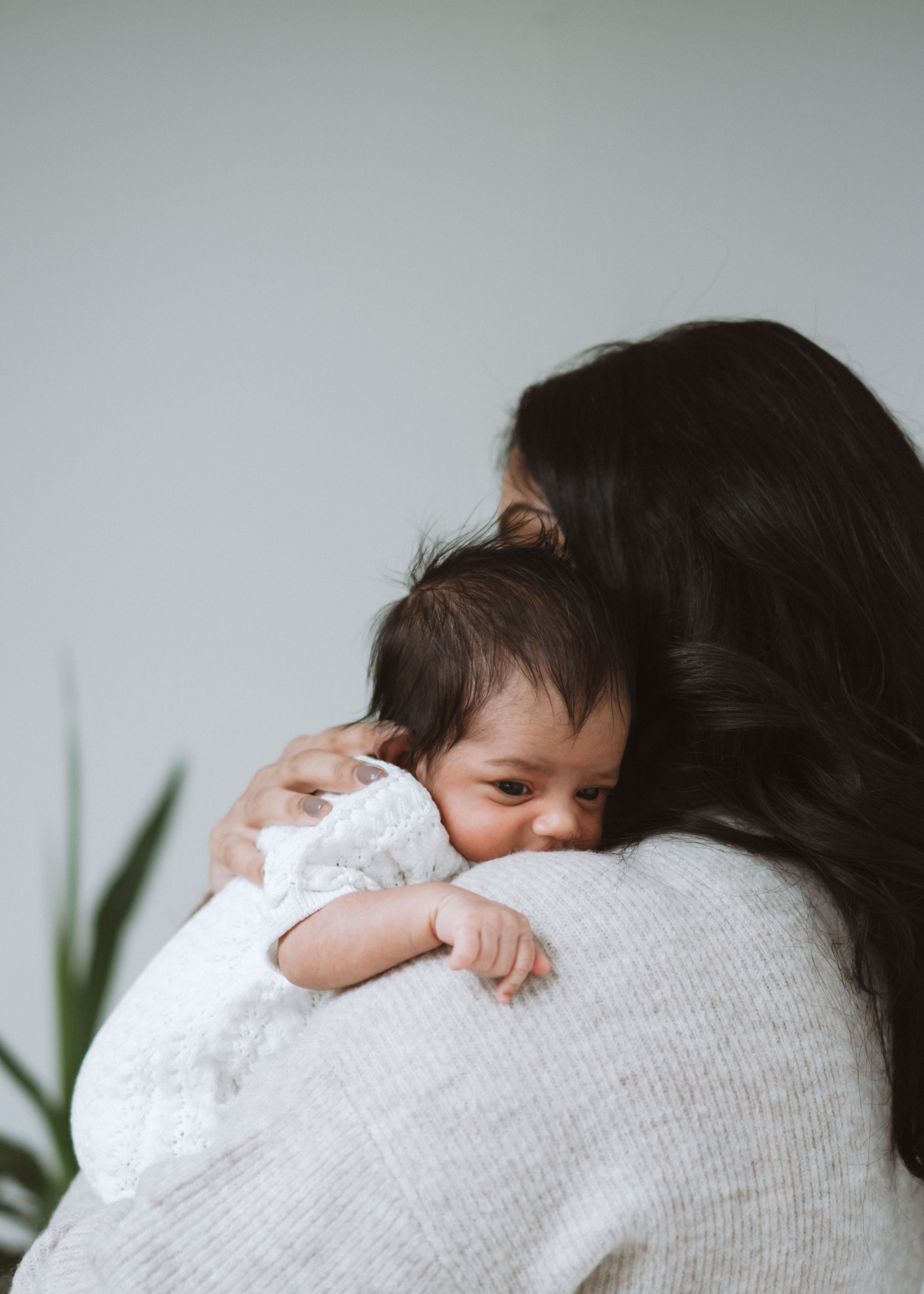 Newborn baby cradled by their parents during a relaxed family photography session