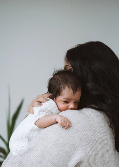 Newborn baby cradled by their parents during a relaxed family photography session