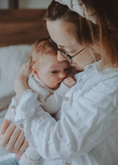 Tender close-up of a parent comforting their newborn baby