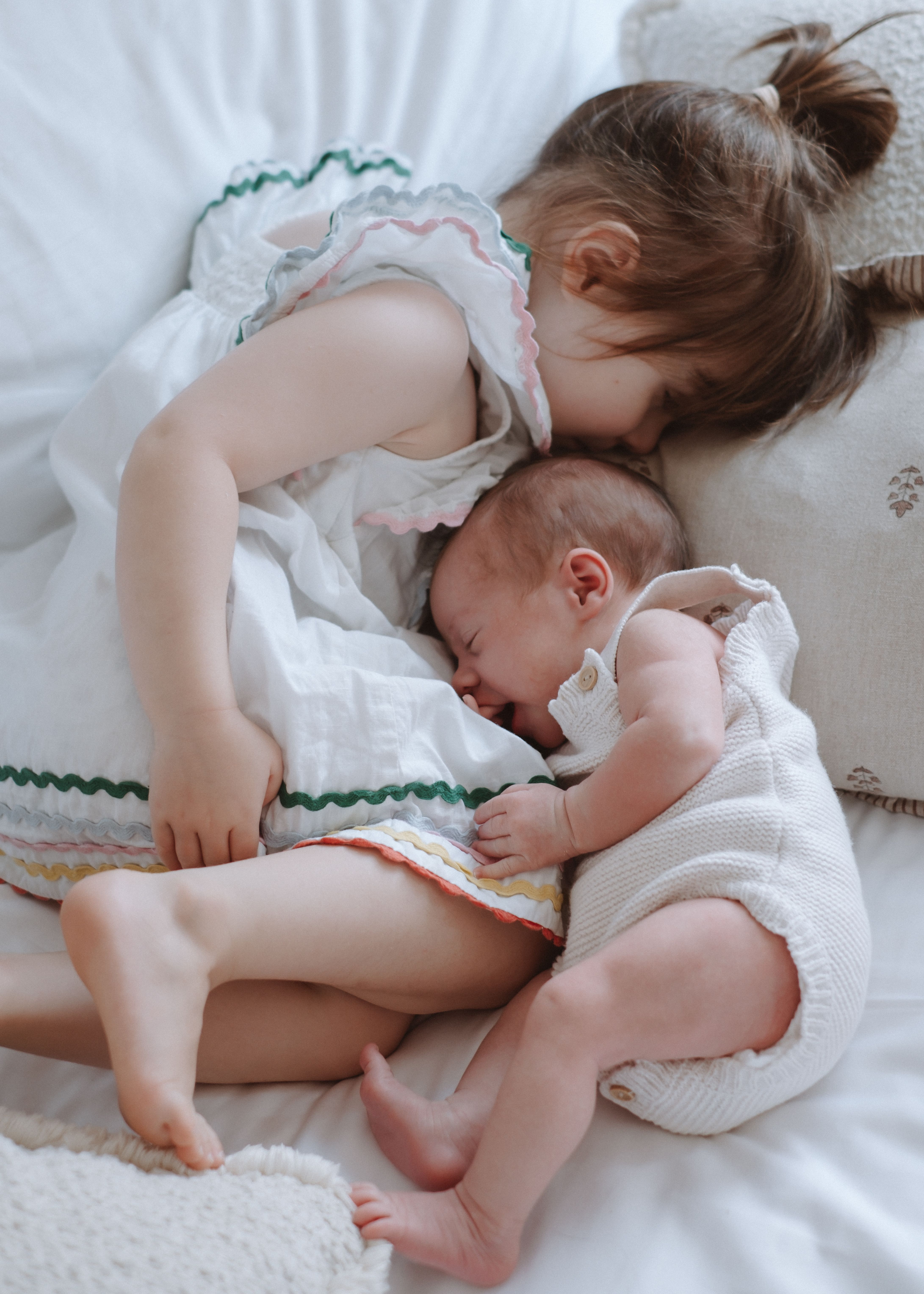 Close portrait of a newborn baby wrapped in soft neutral blankets