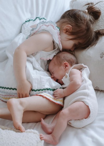 Close portrait of a newborn baby wrapped in soft neutral blankets
