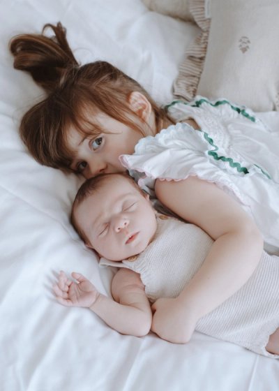 Newborn baby cradled by their parents during a relaxed family photography session