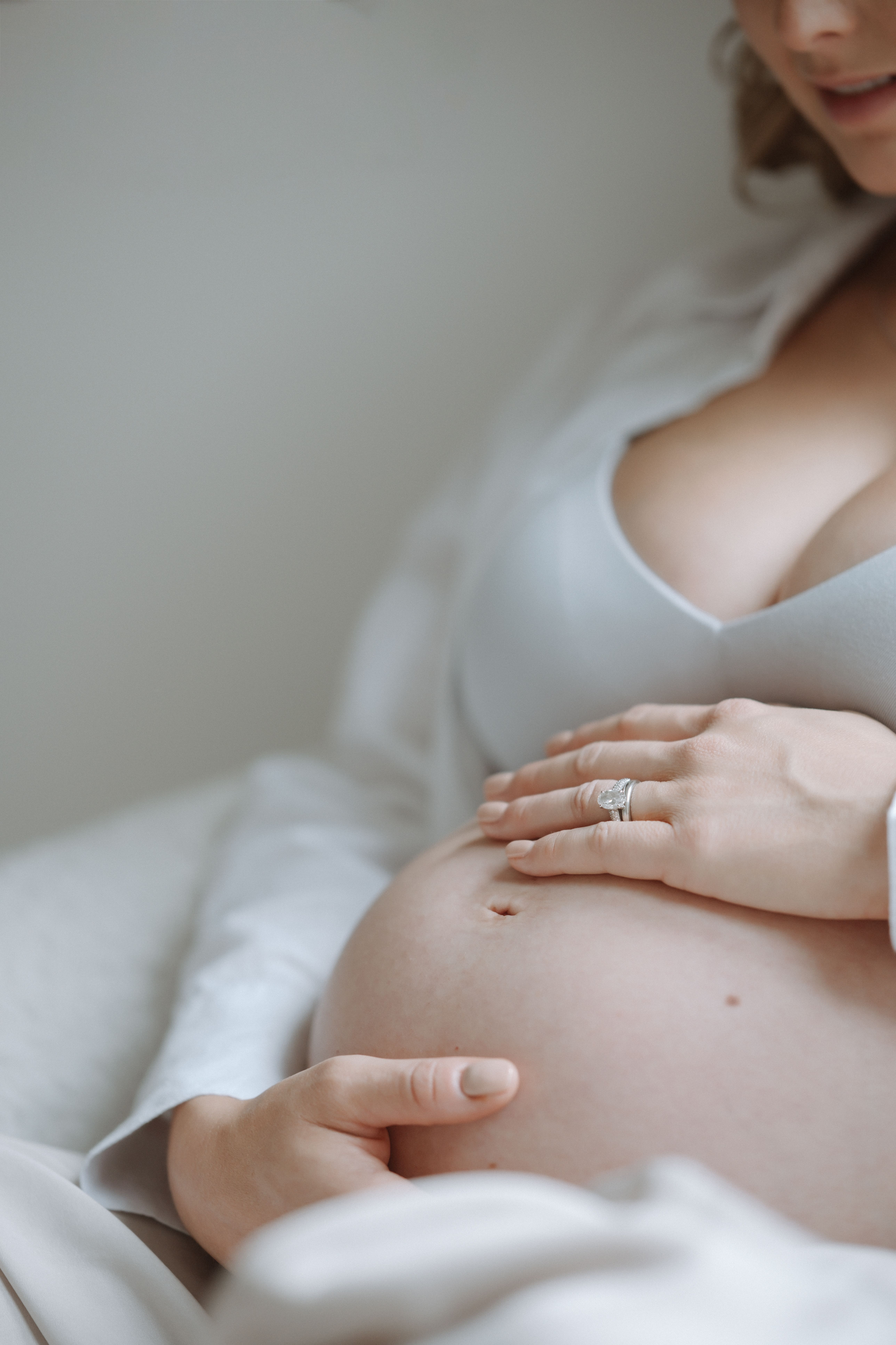 Close-up of an expectant mother cradling her pregnancy bump