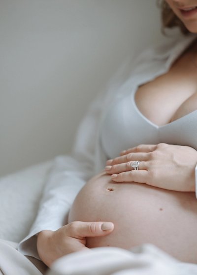 Close-up of an expectant mother cradling her pregnancy bump
