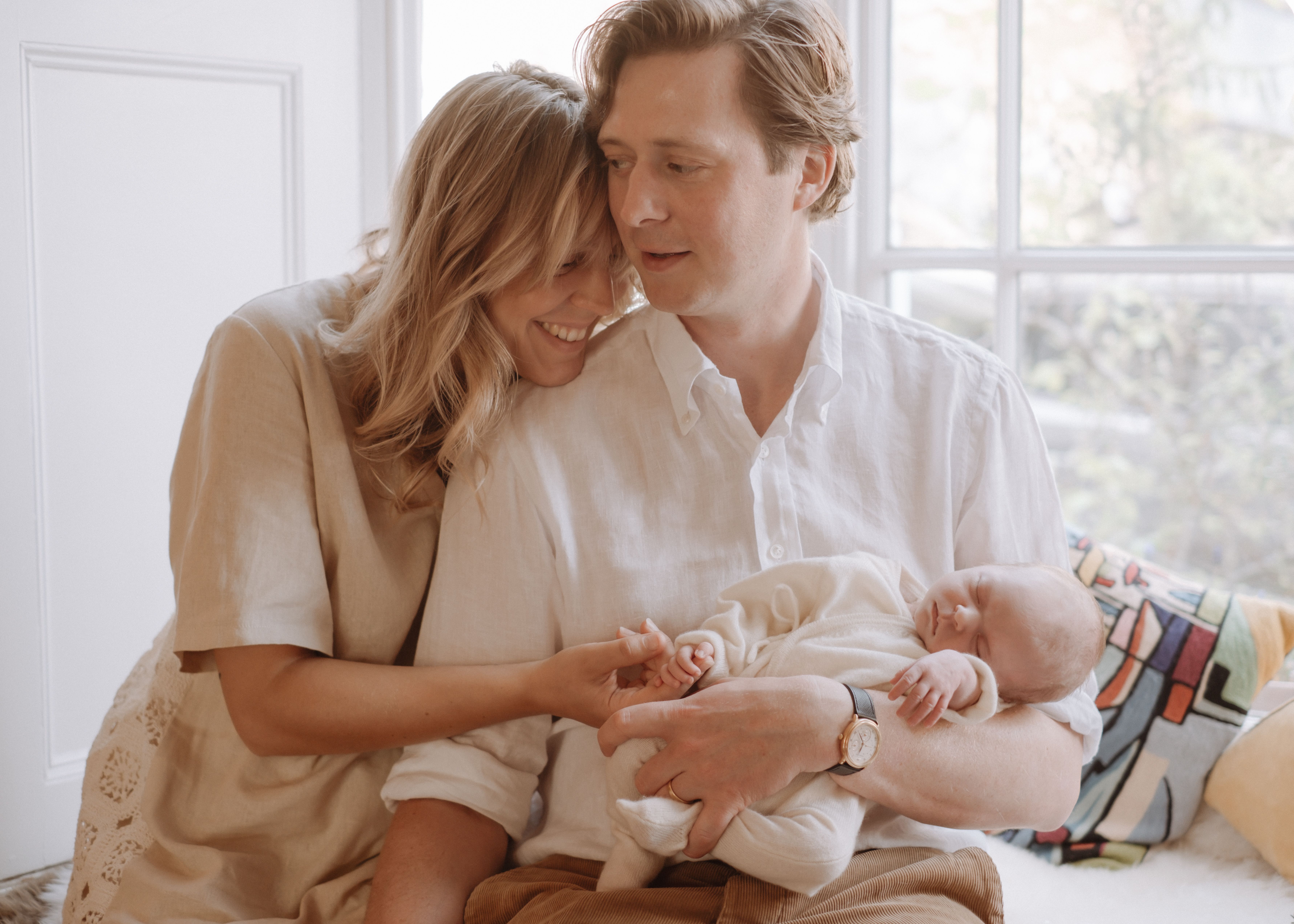 Parents sharing a quiet moment with their newborn baby at home