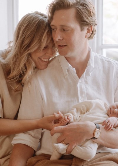 Parents sharing a quiet moment with their newborn baby at home