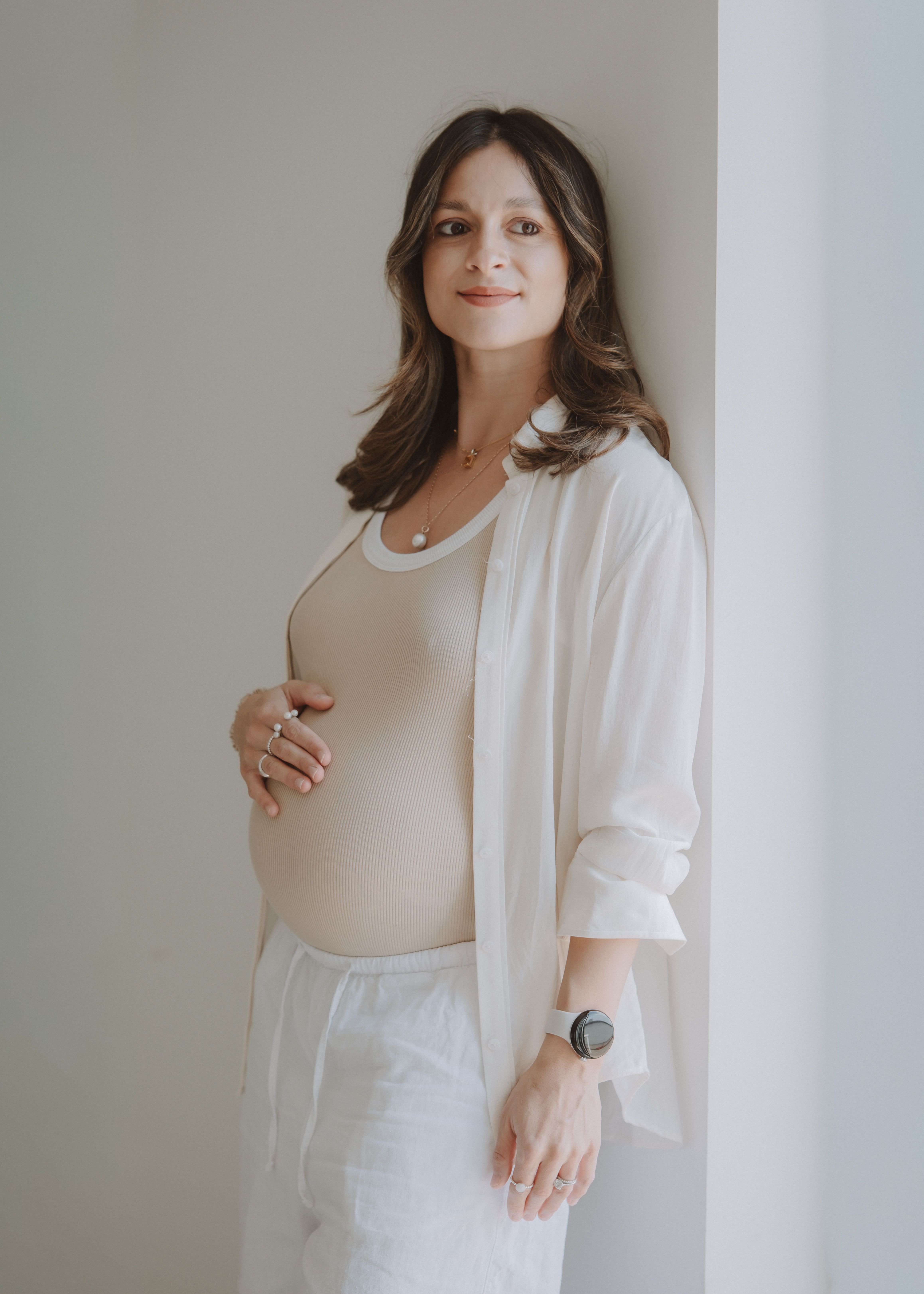 Close-up of an expectant mother cradling her pregnancy bump