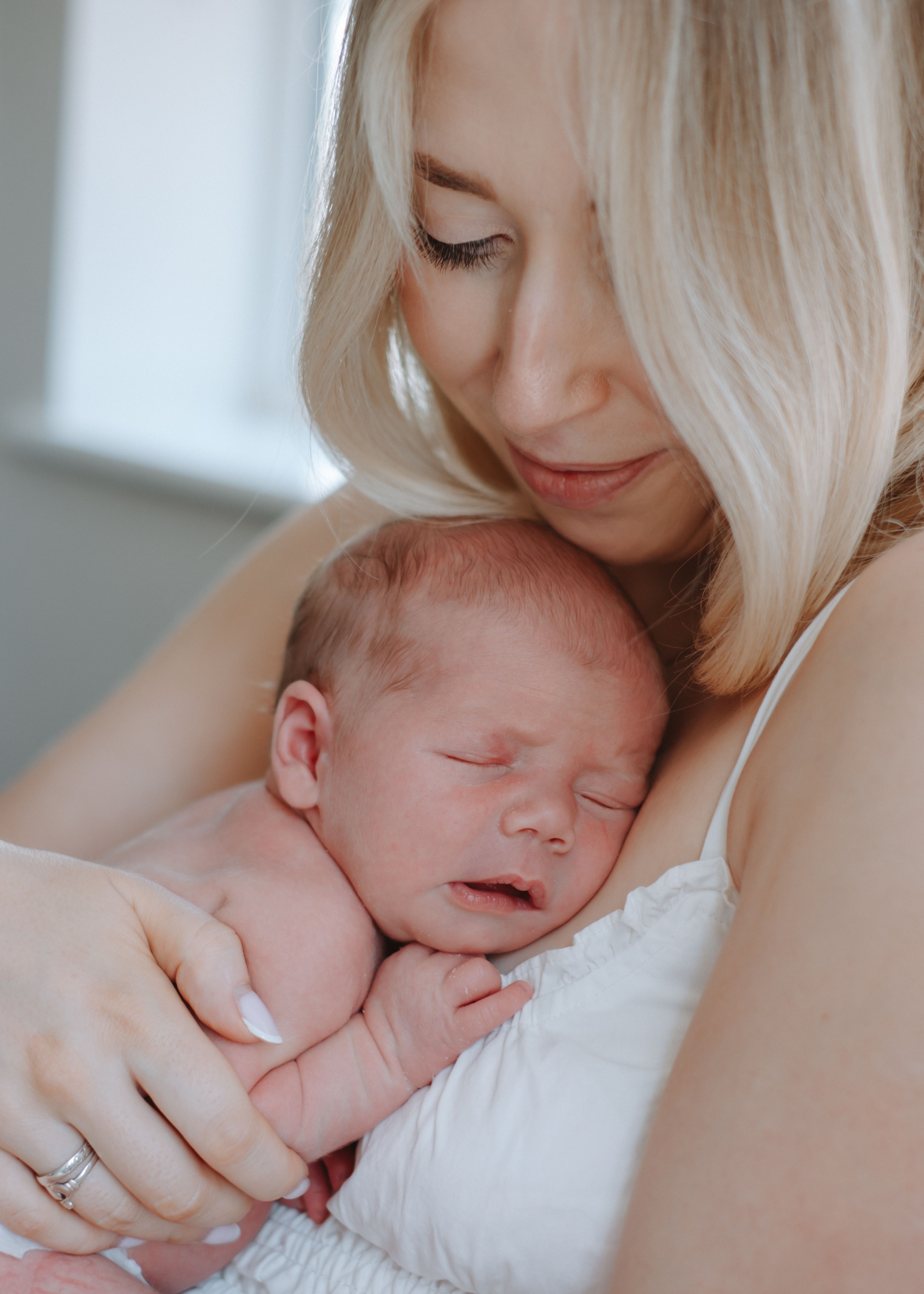 Newborn baby awake and looking towards the camera at home