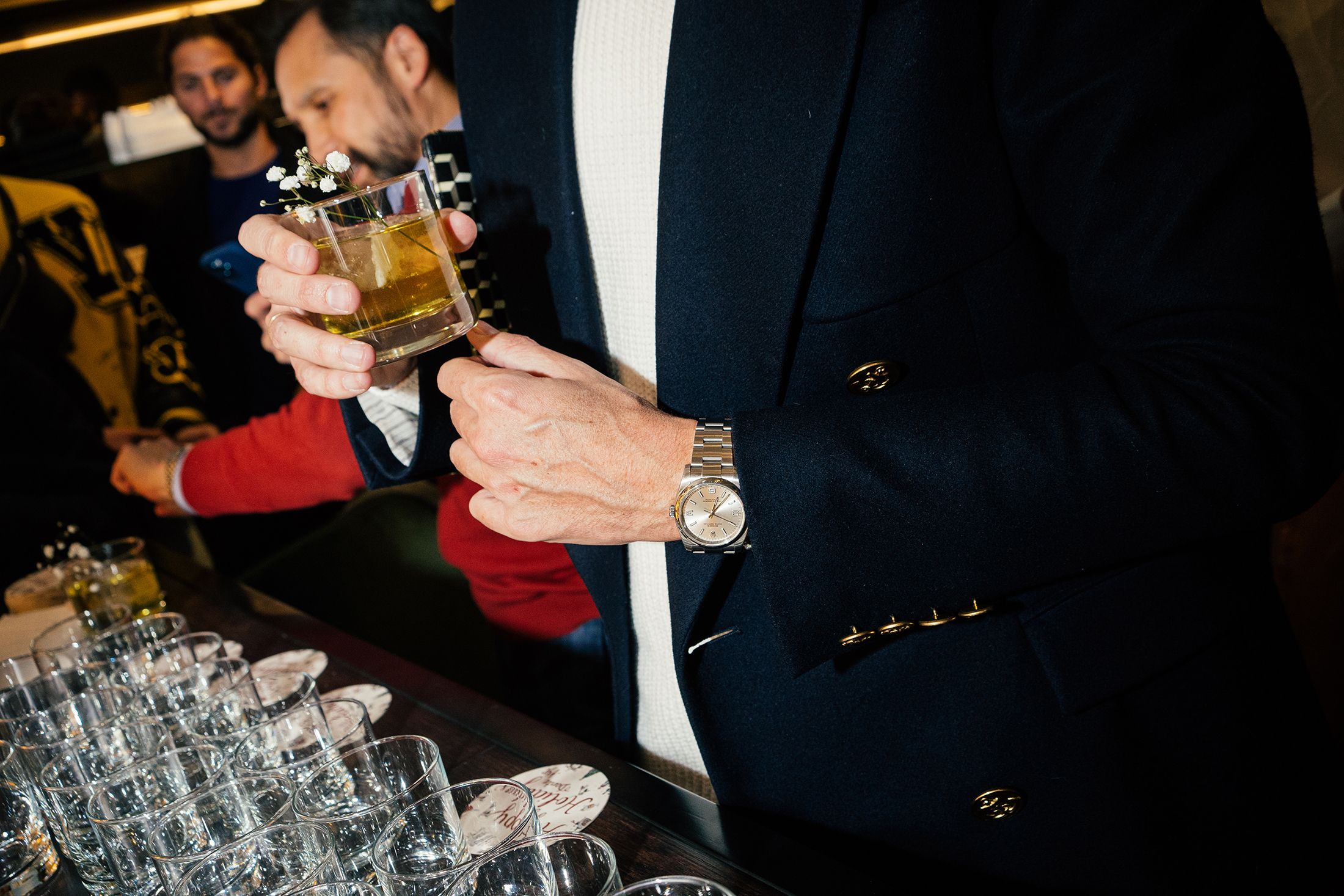 Guest holding a cocktail near the bar during an event catering reception.