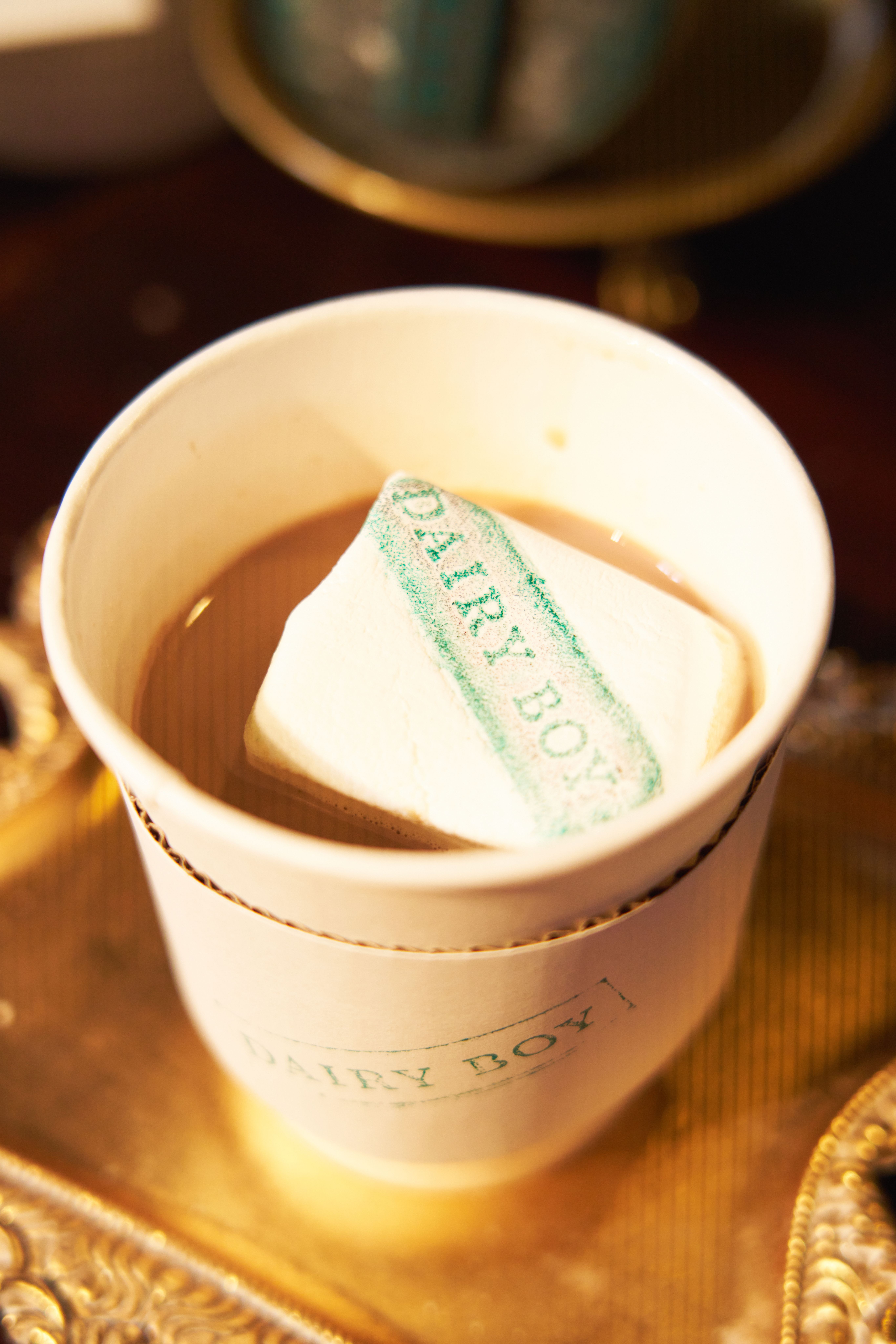Branded hot chocolate with marshmallow served during a winter brand experience event.
