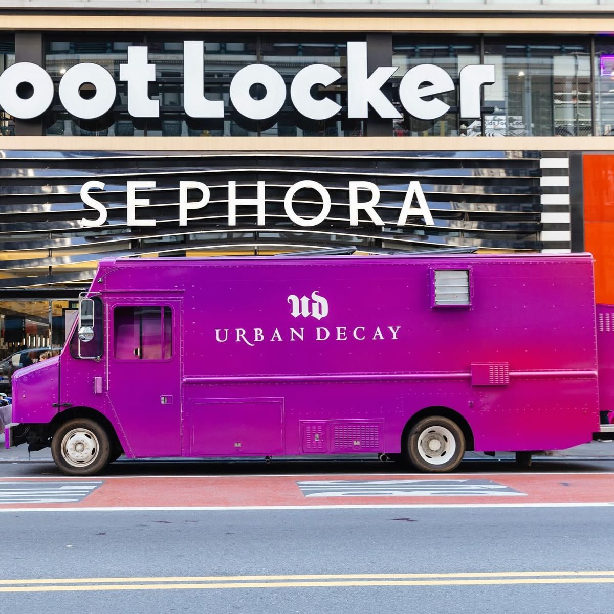 Urban Decay branded pop-up truck parked outside Sephora and Foot Locker during a street-level brand activation event.