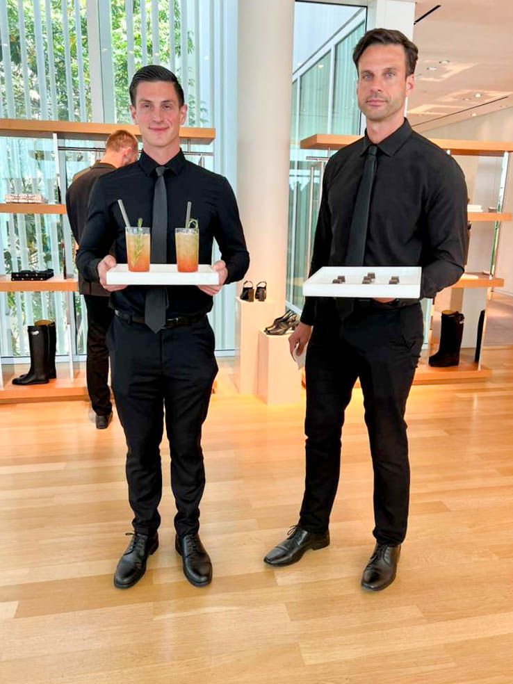 Professional event catering staff serving cocktails and bite-sized canapés at a brand, in-store or corporate event.