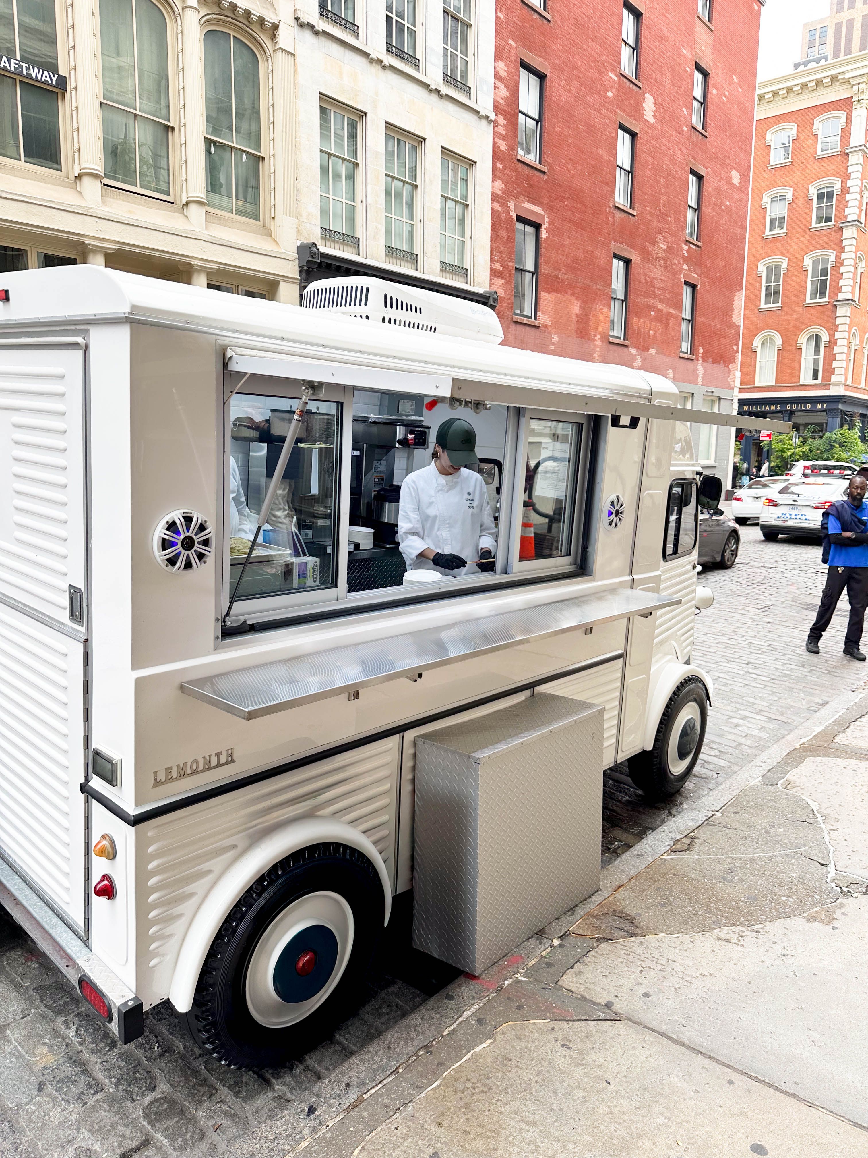 Mobile catering food truck set up on a city street for a brand activation event.
