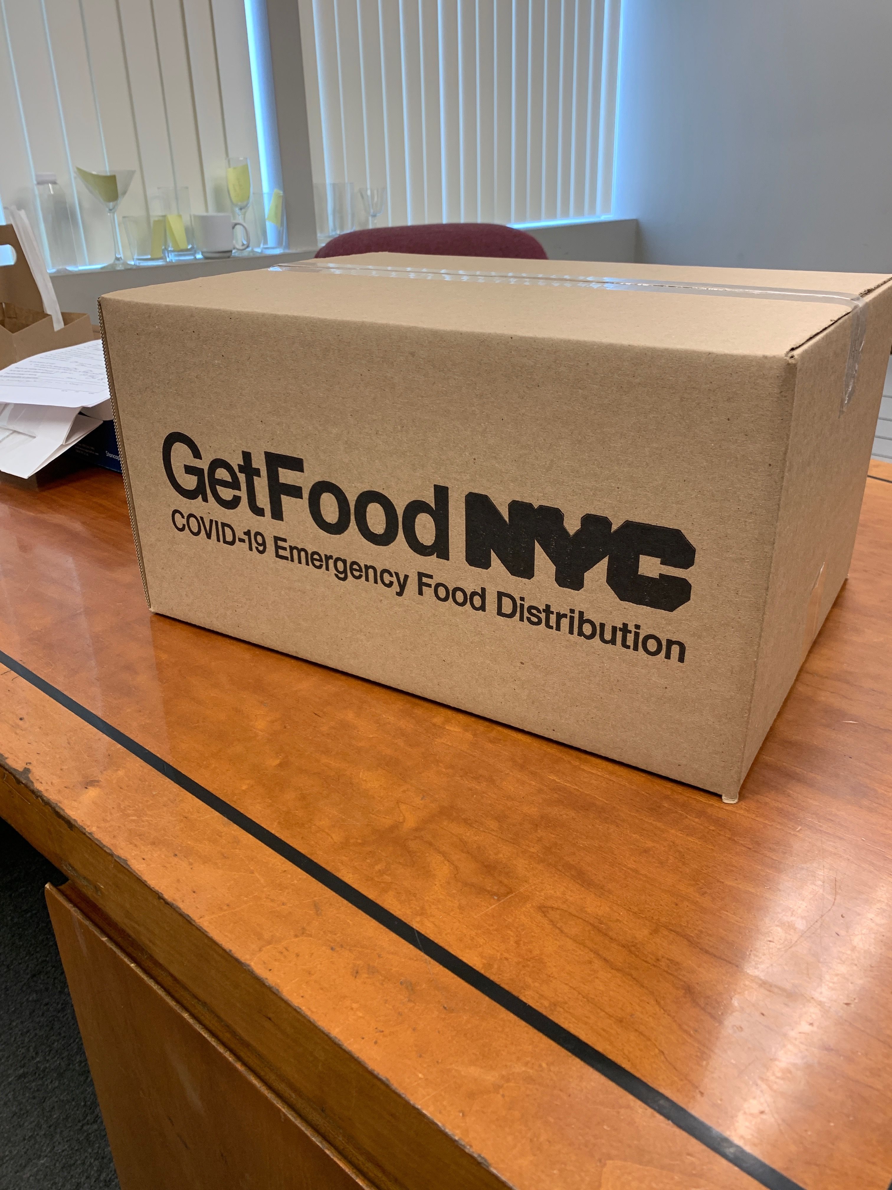 Box of packaged meals prepared for emergency food distribution during crisis response.