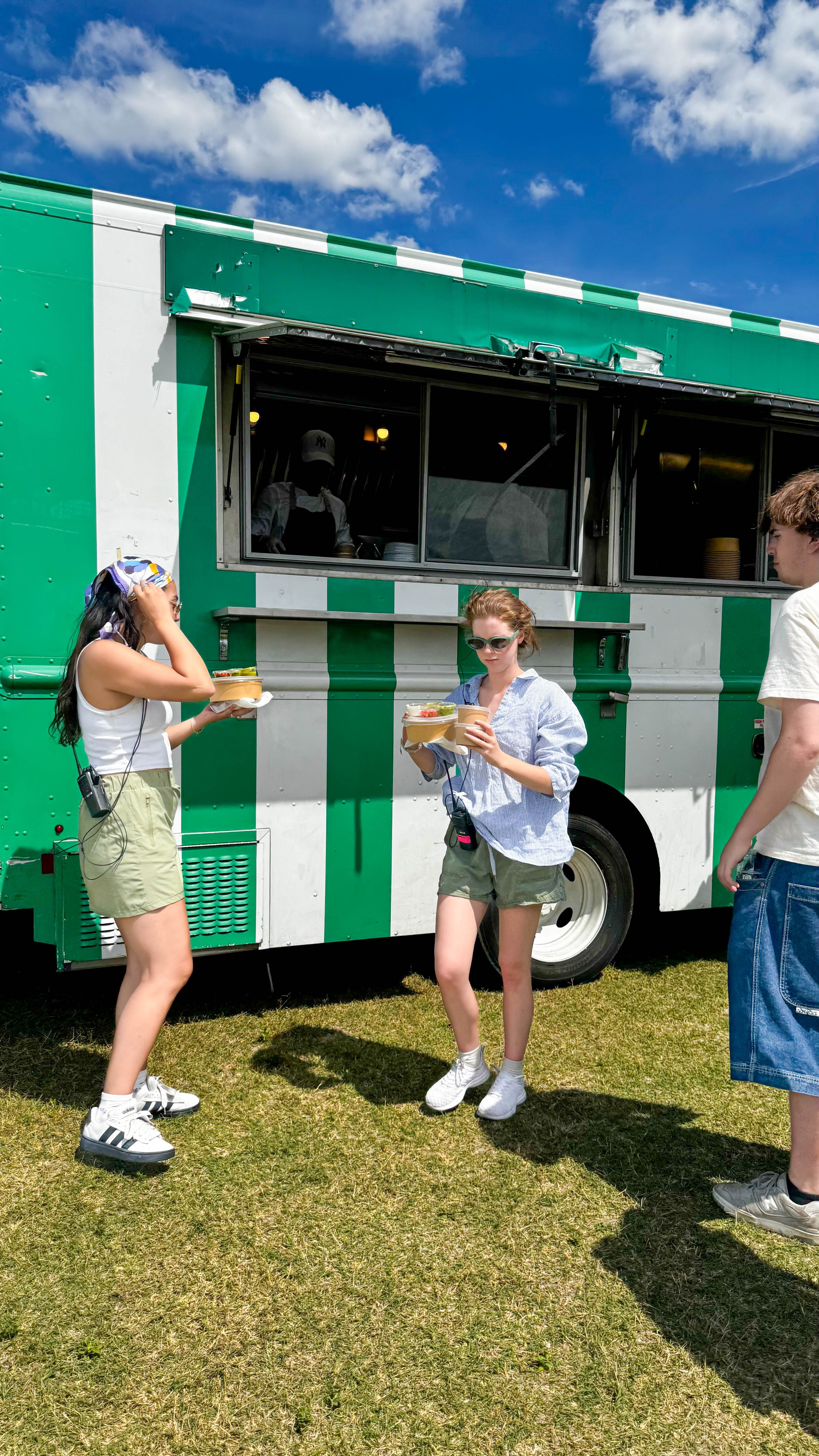 Guests enjoying meals from the Lemons and Olives catering food truck at an outdoor event.