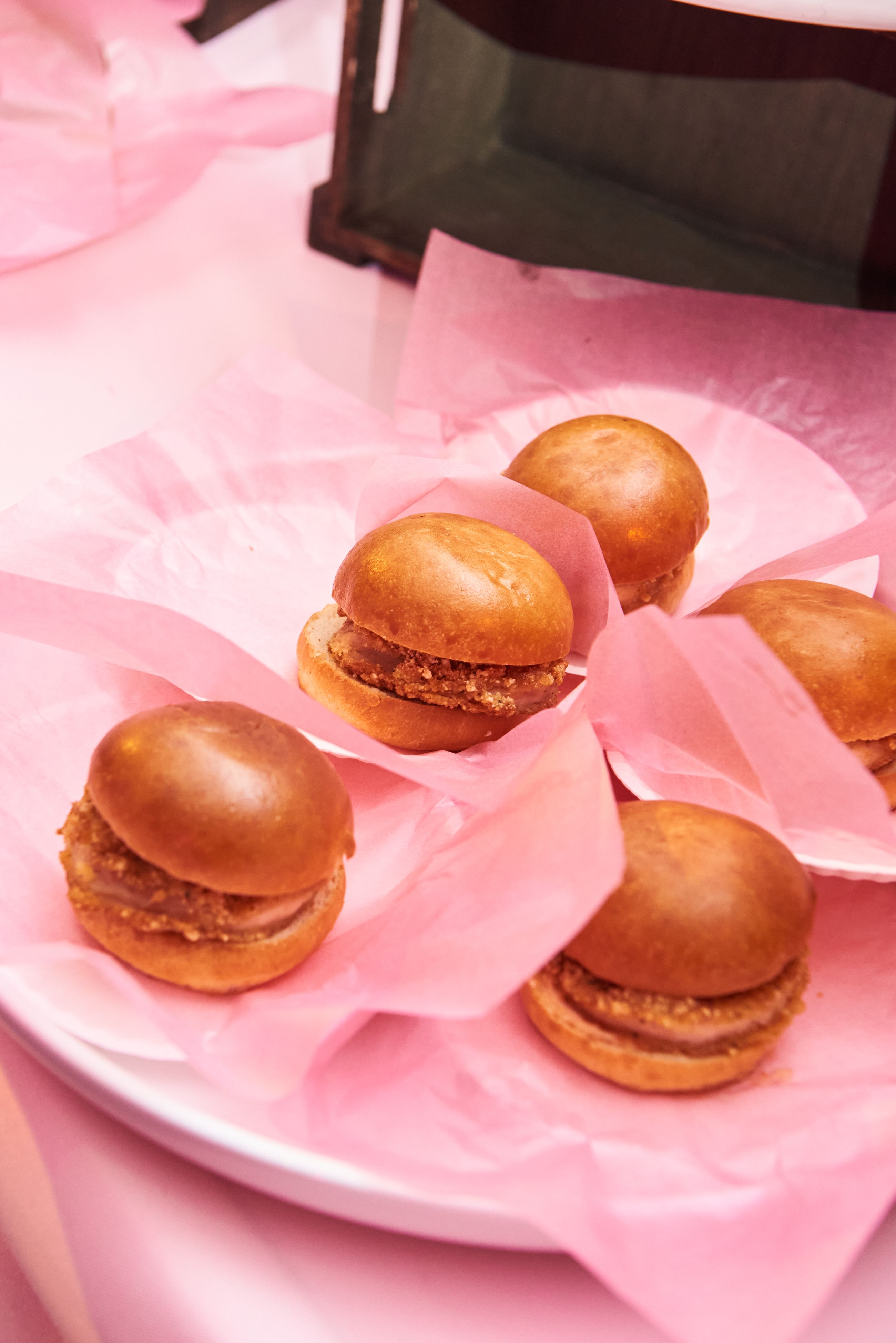 Mini gourmet sliders served as passed appetizers during a luxury brand experience event.