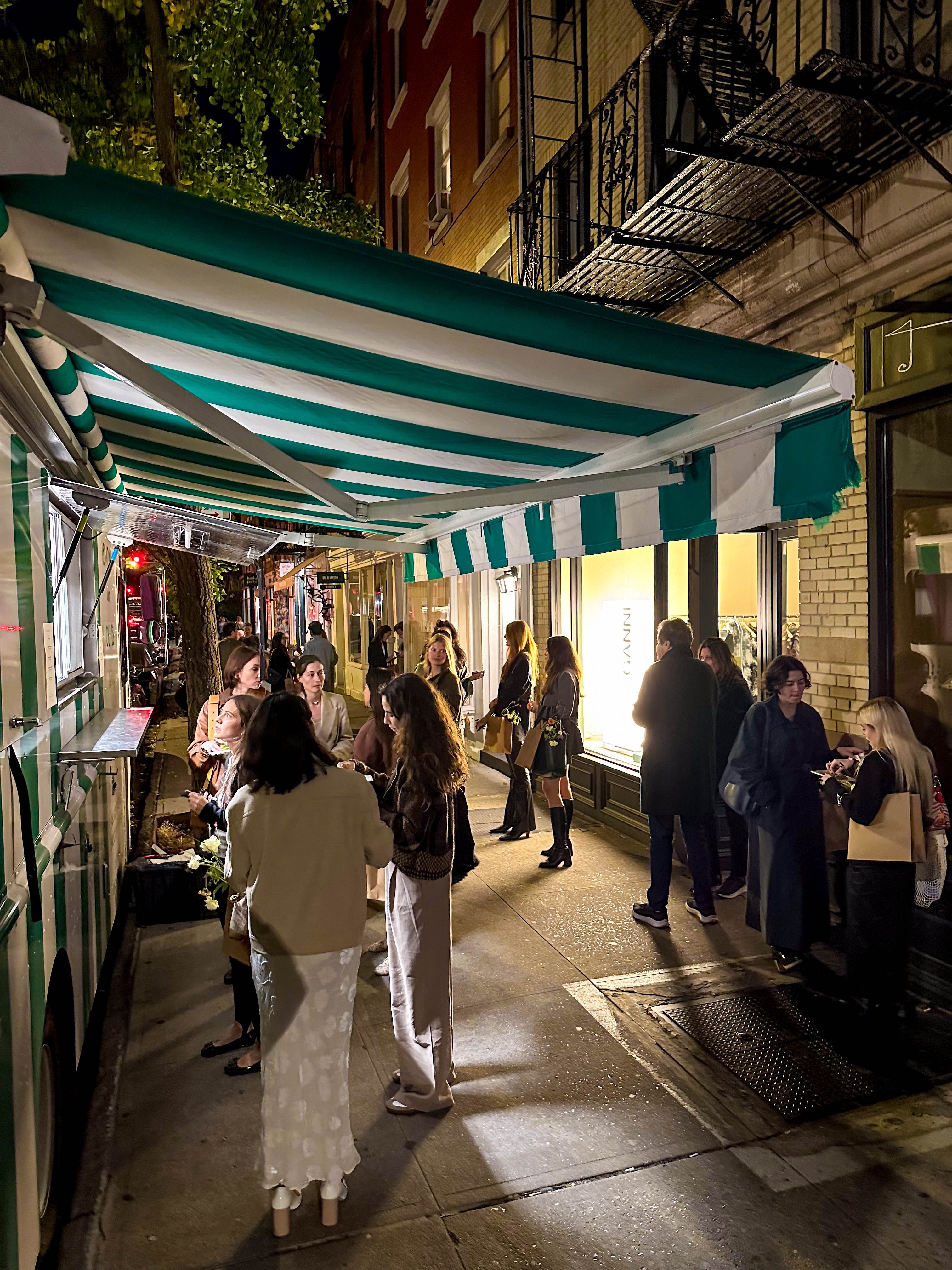 Guests gathered outside a pop-up catering setup on a New York City street.