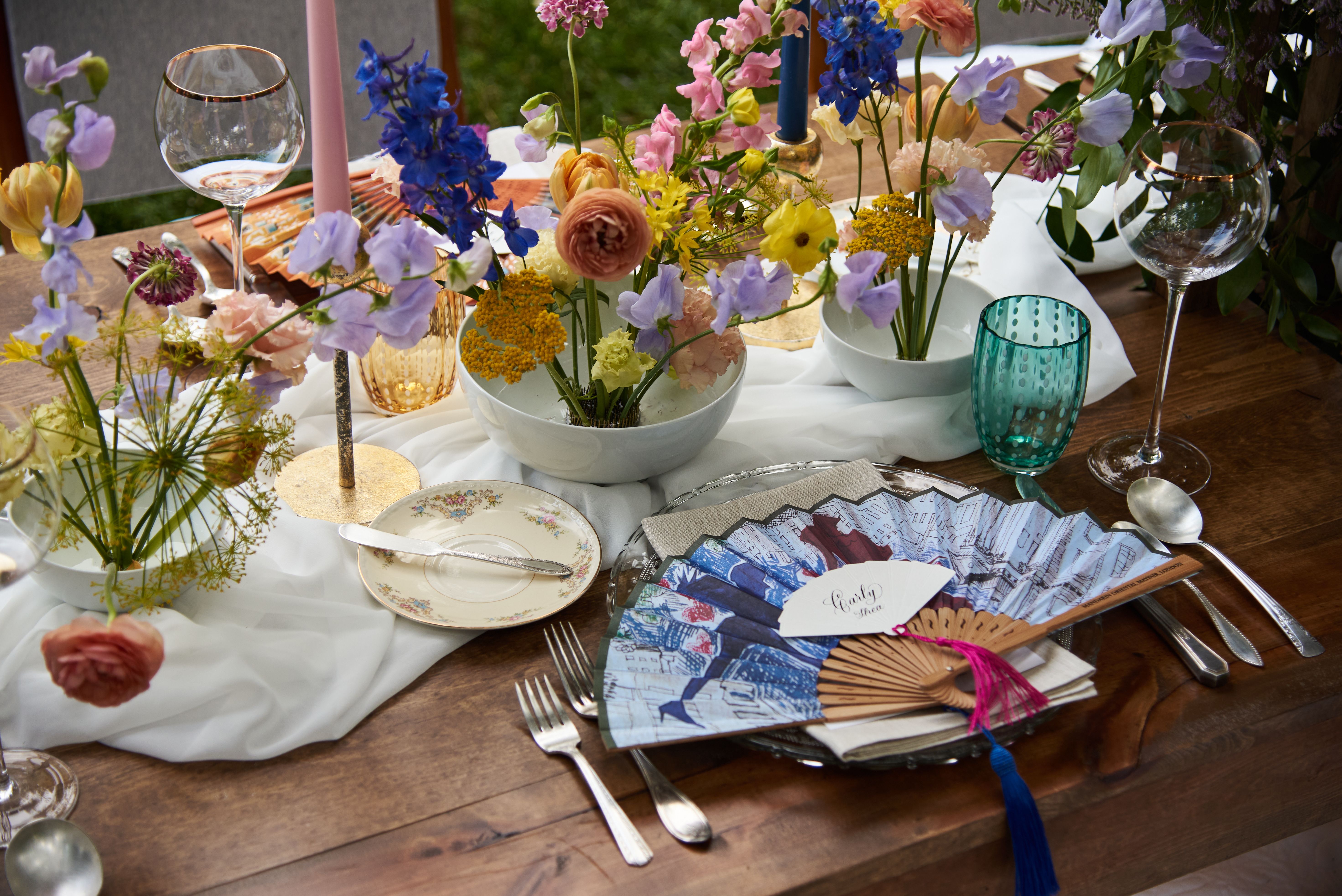 Styled event table with floral centerpieces created for a branded experiential event.