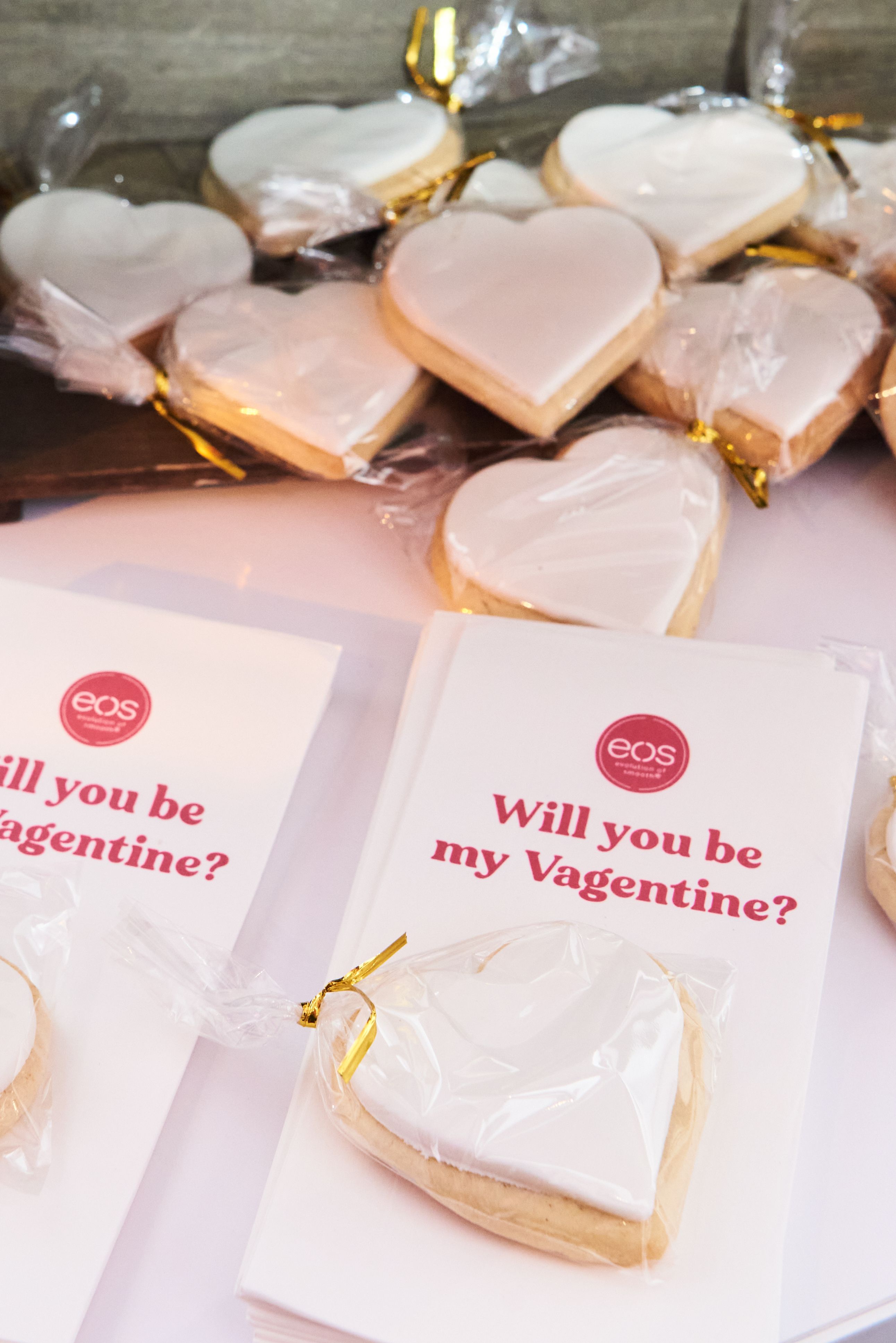 Heart-shaped iced cookies packaged as branded favors at a Valentine’s themed catered event